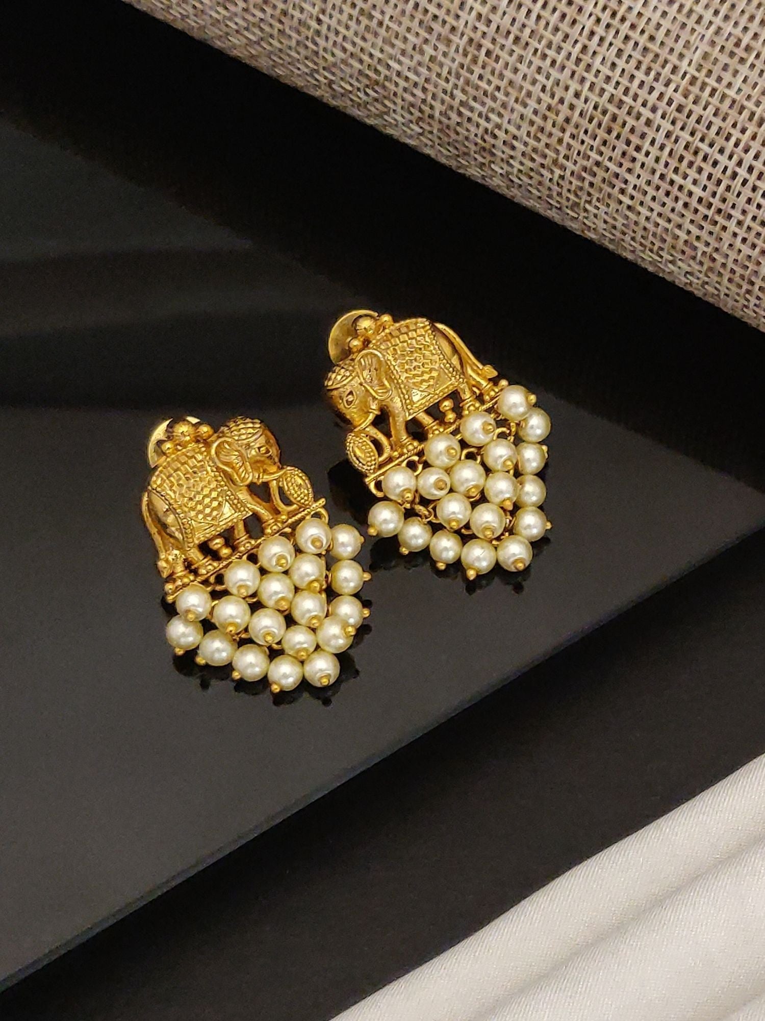 Gold plated elephant earrings with intricate design and pearl bead detailing by Abdesignsjewellery