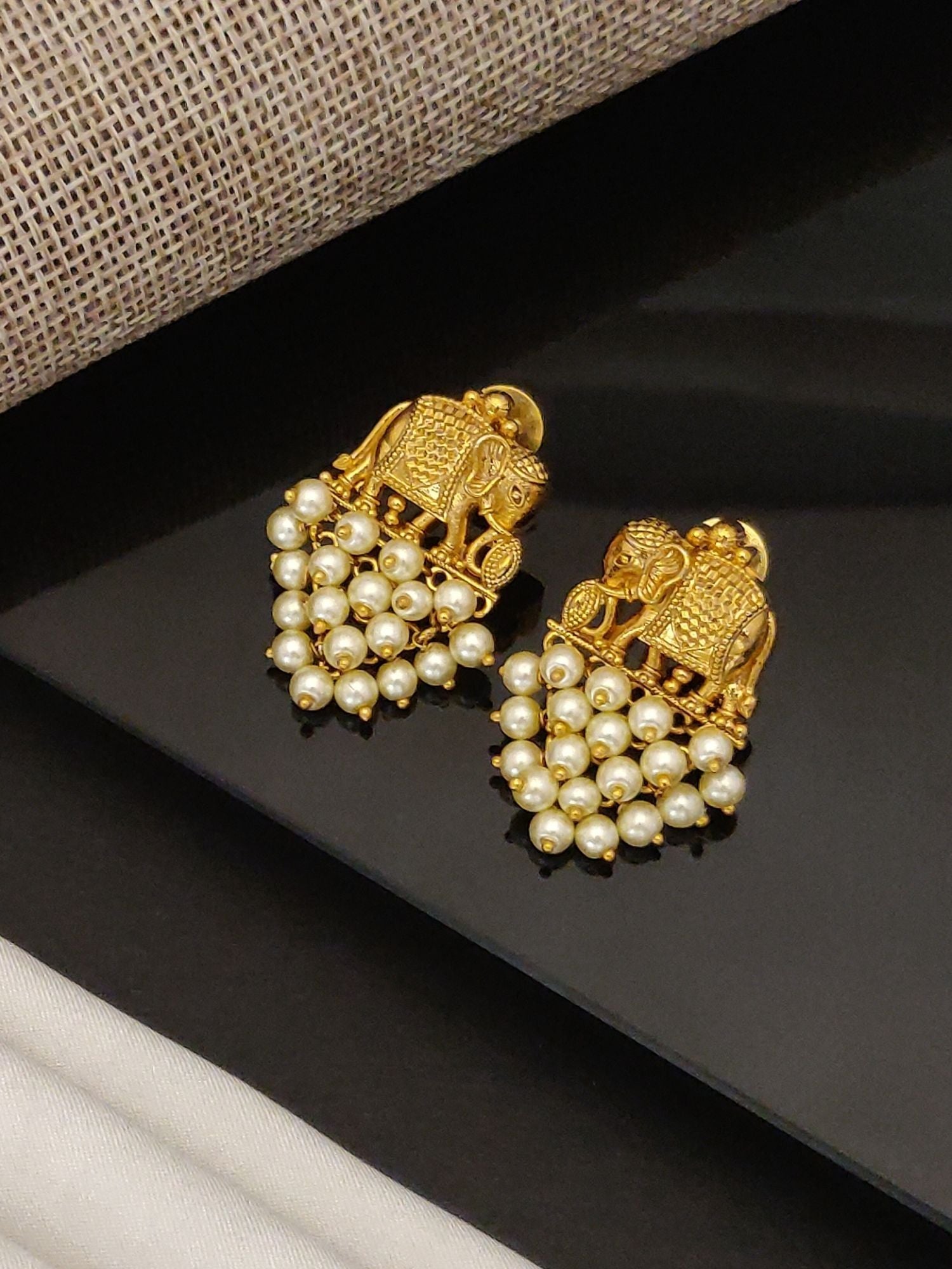 Gold plated elephant earrings with intricate design and pearl cluster accents by Abdesignsjewellery