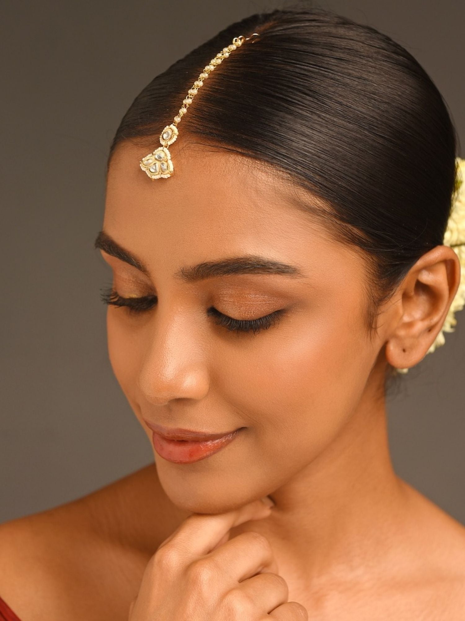 Gold Plated Kundan Maangtikka worn by woman with sleek hair and neutral makeup by Abdesignsjewellery