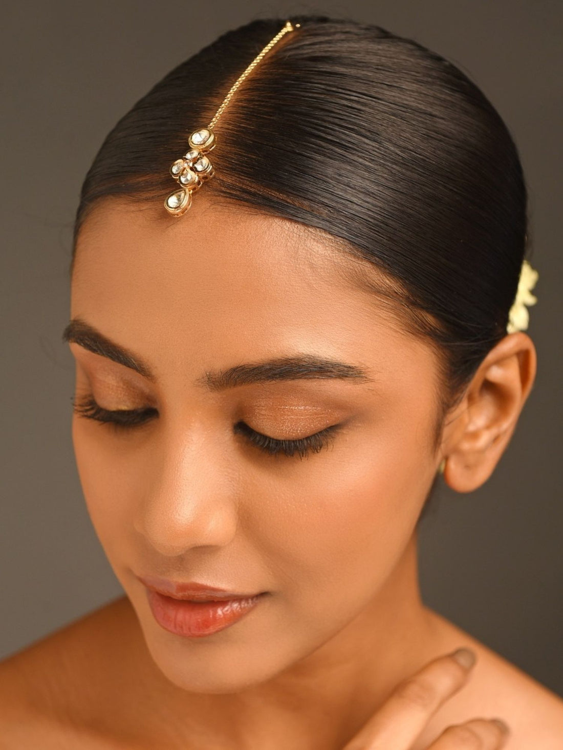 Gold Plated Kundan Maangtikka worn by woman with sleek hair and natural makeup from Abdesignsjewellery