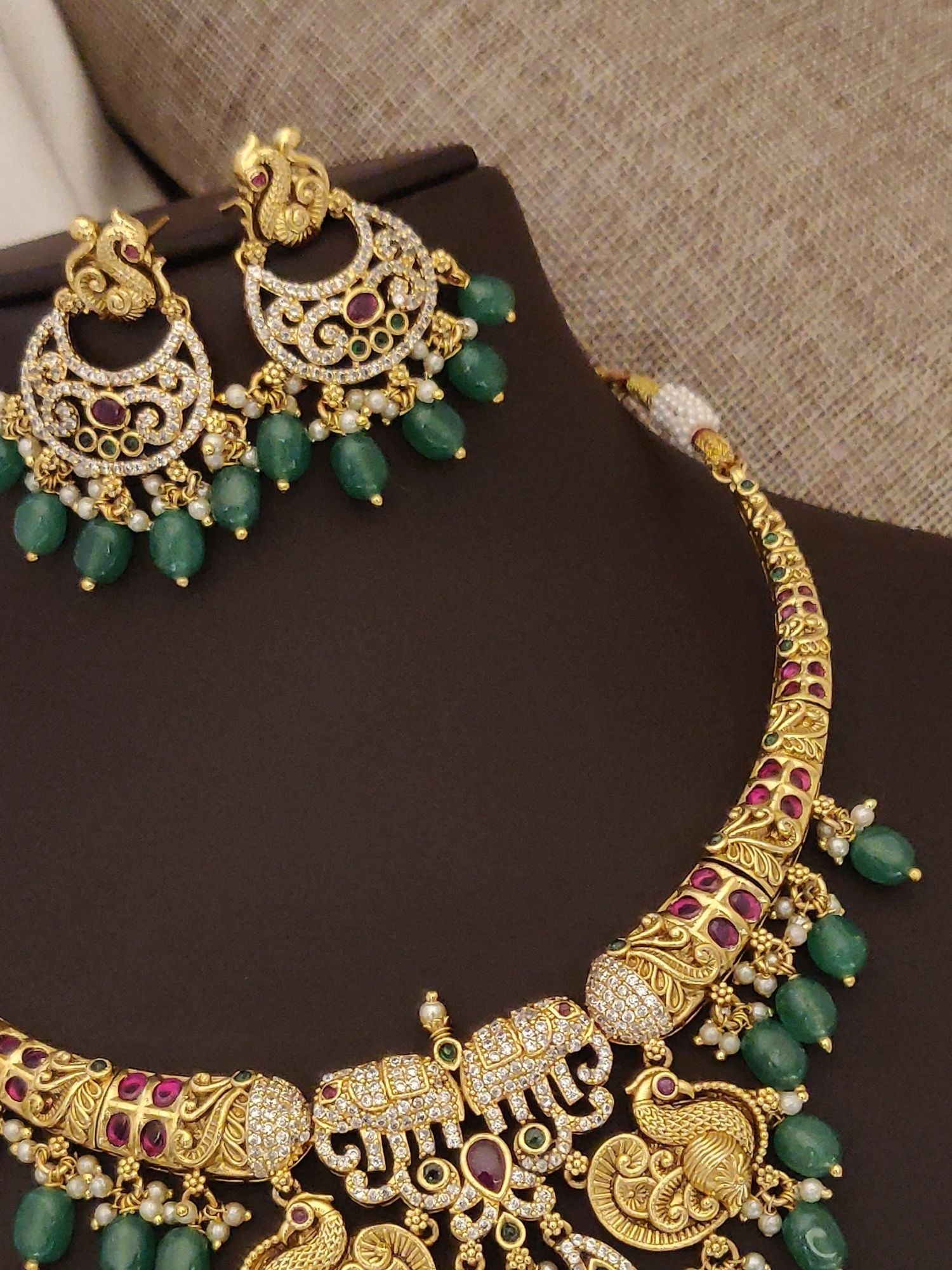 Elegant gold plated multicolor diamond necklace set with intricate details and matching earrings
