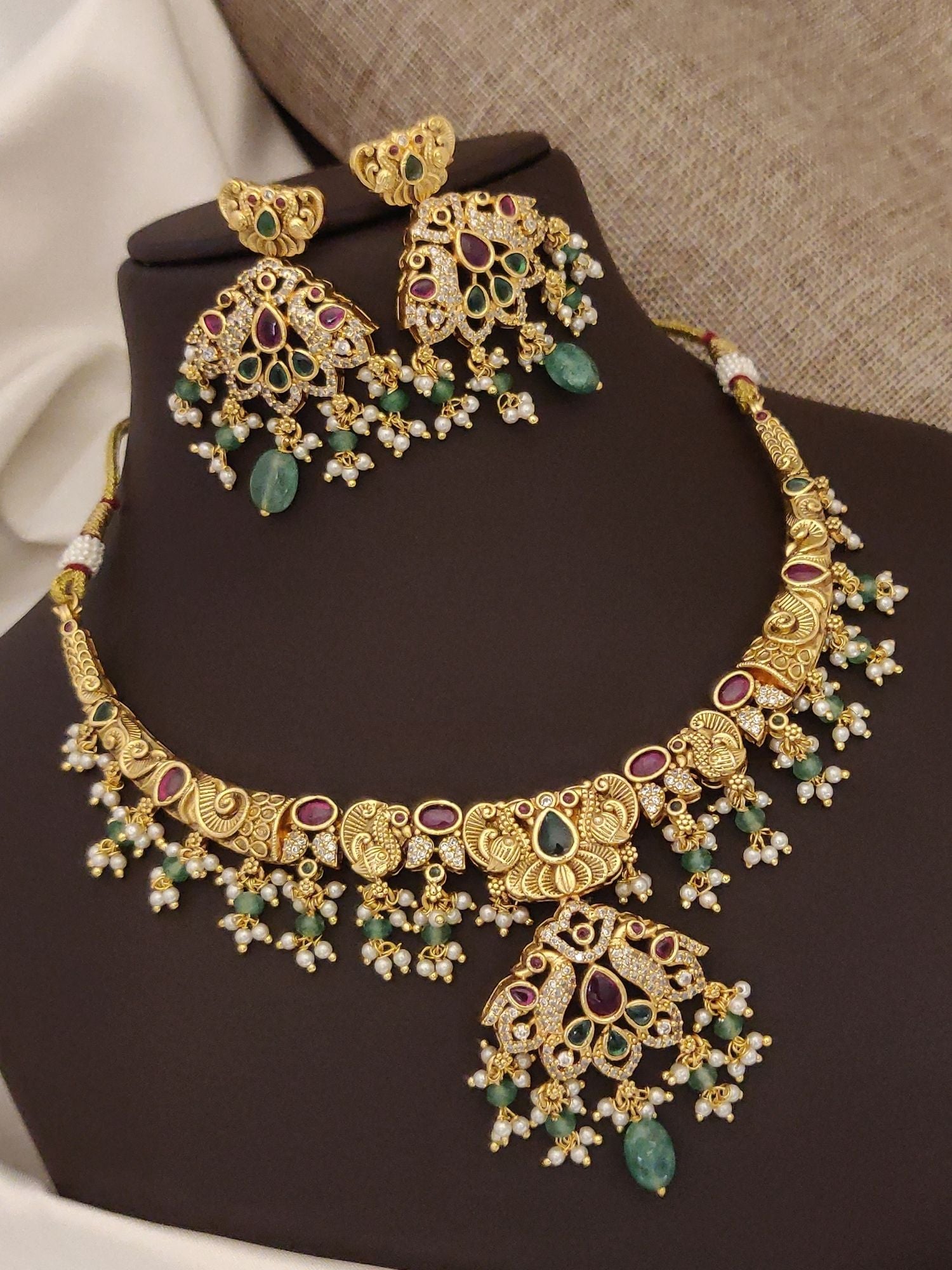 Gold plated multicolor necklace set with intricate design and matching earrings for elegant occasions