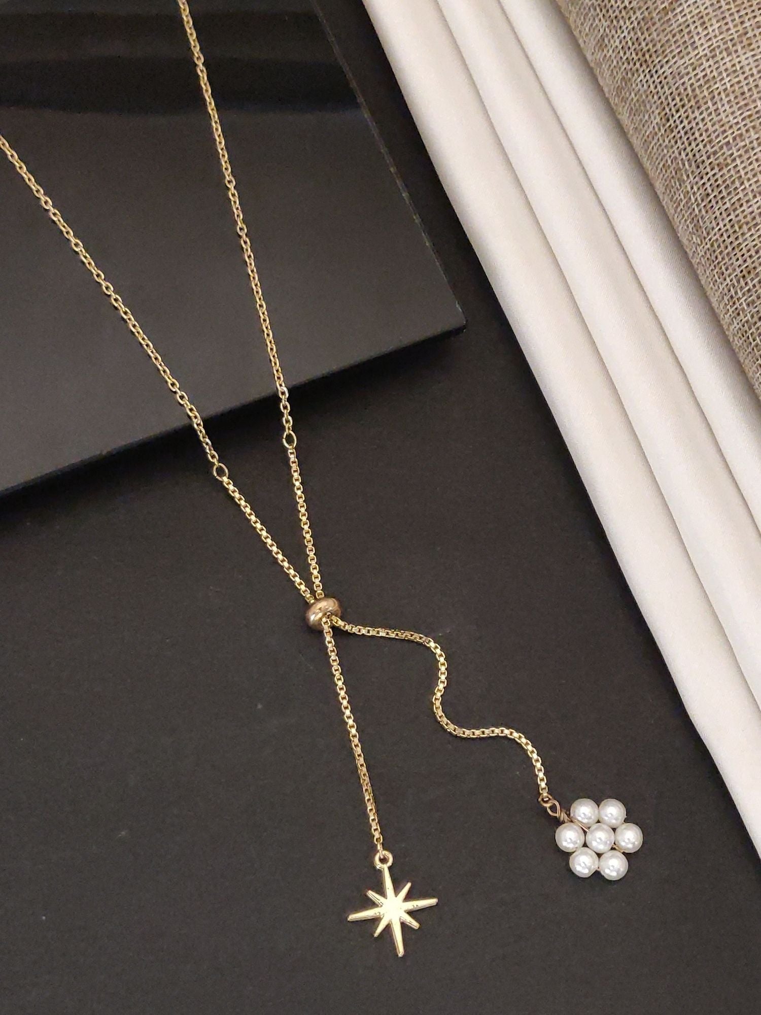 Gold plated pendant necklace featuring a star charm and pearl flower design for elegant styling