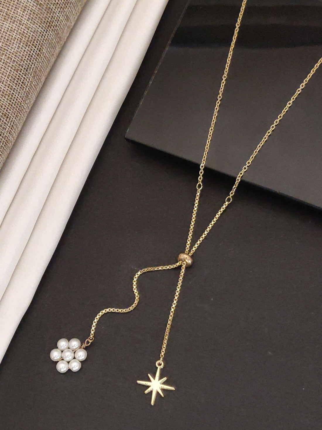 Gold plated pendant necklace featuring a star charm and pearl flower design for elegant styling