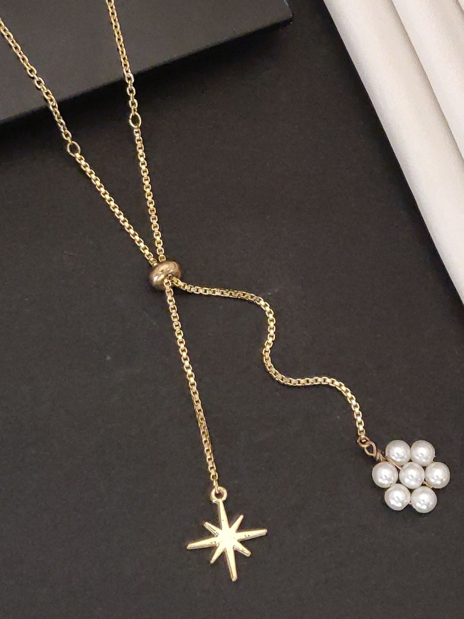Elegant gold plated pendant necklace with a star charm and pearl accents for a stylish look