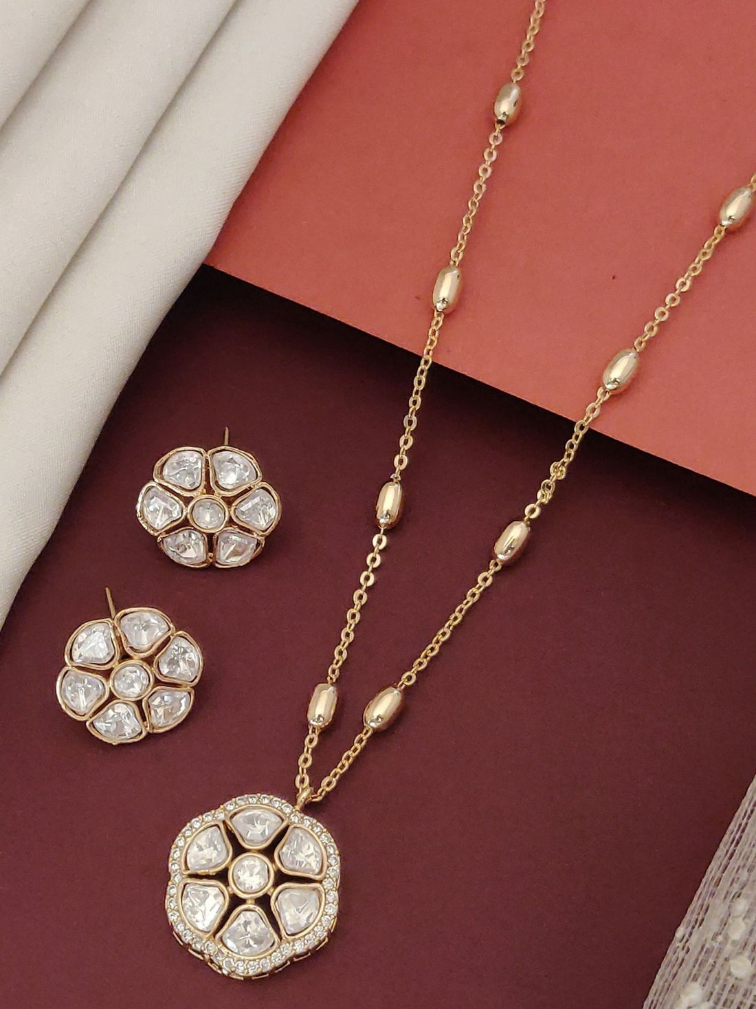Gold plated Polki flower necklace set featuring a statement pendant and matching earrings for elegant occasions