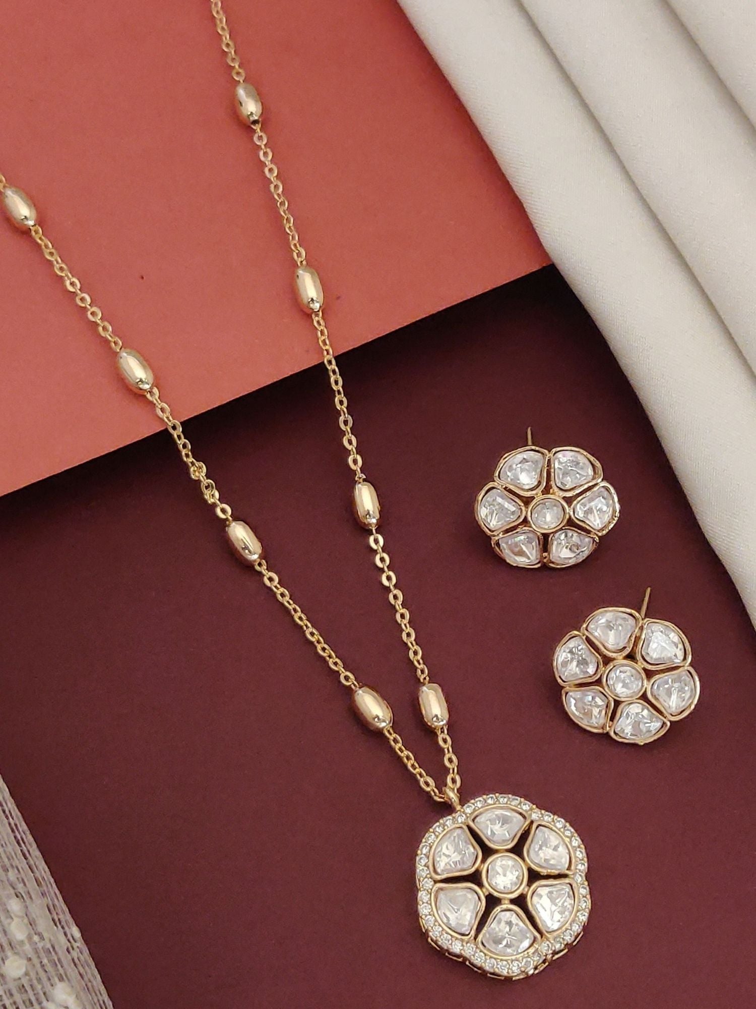 Gold plated Polki flower necklace set with matching earrings on a stylish background