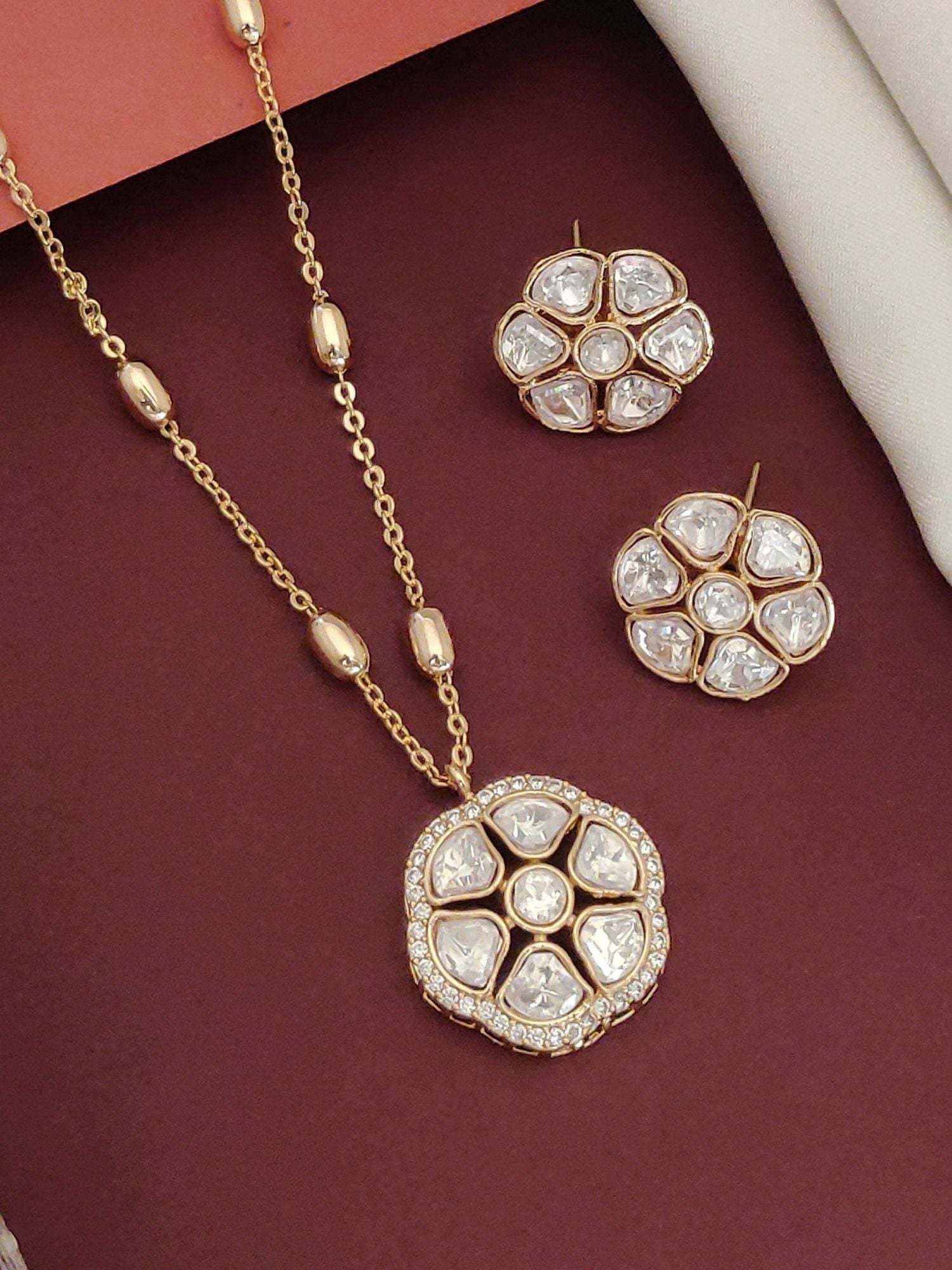Gold plated Polki flower necklace set featuring a statement pendant and matching earrings for elegant occasions