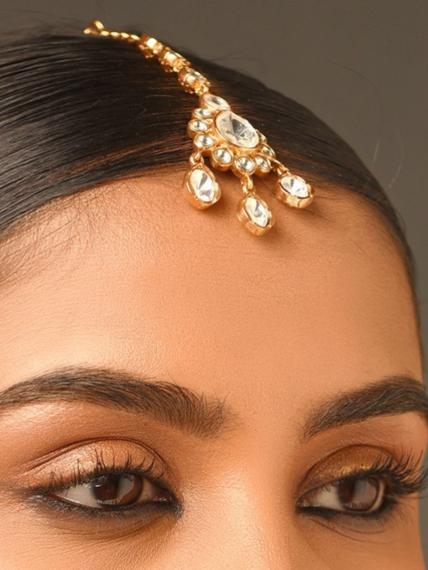 Gold Plated Polki Maangtikka by Abdesignsjewellery worn on forehead with intricate stone detailing