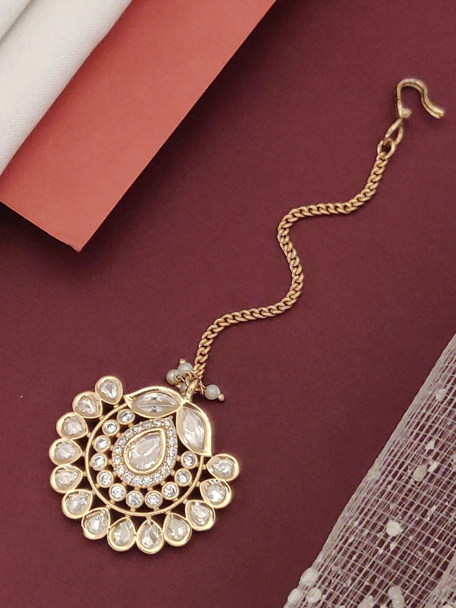 Gold Plated Polki Maangtikka with intricate design featuring sparkling gemstones and elegant chain