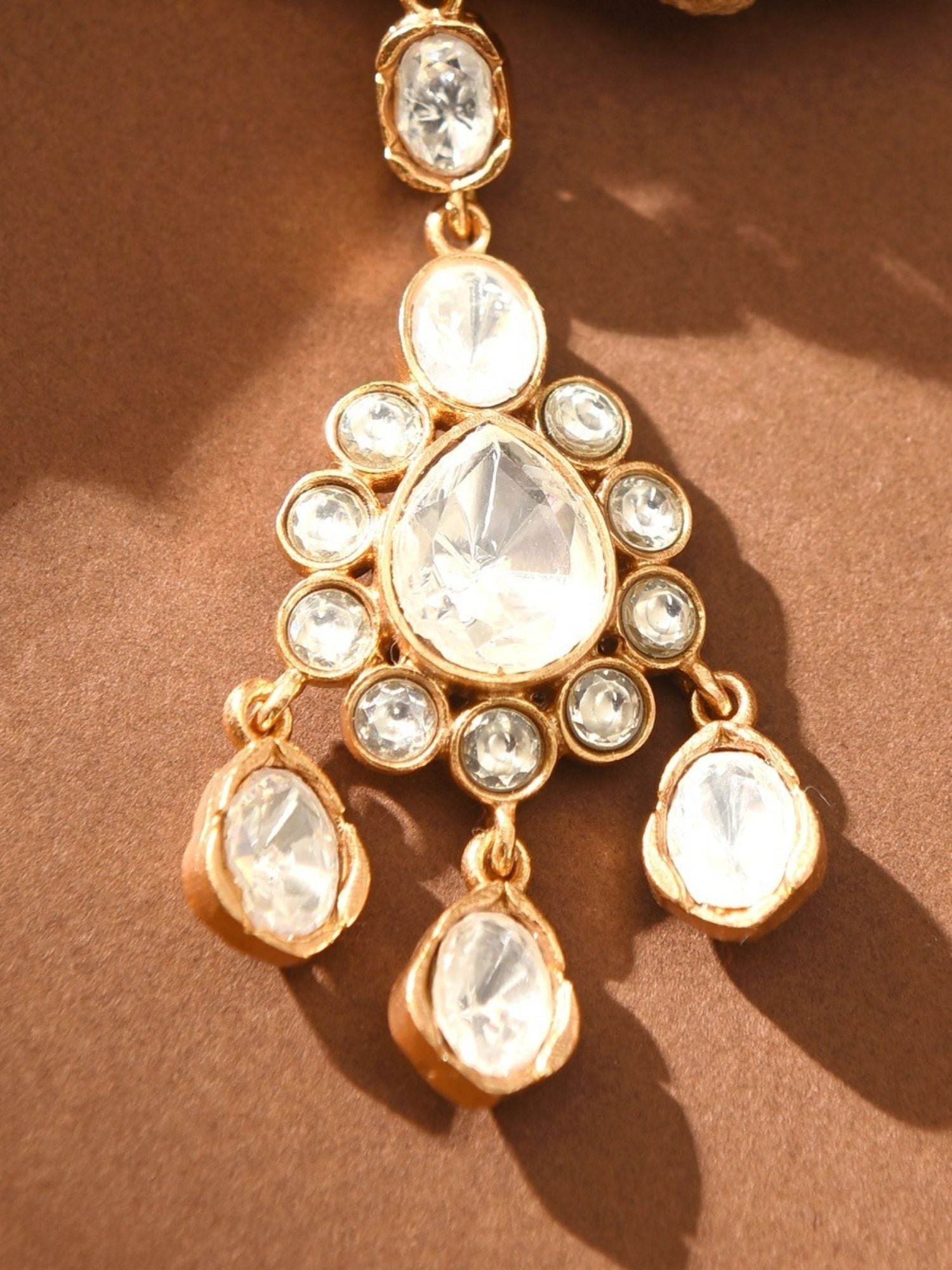 Gold Plated Polki Maangtikka with clear stones and intricate floral design from Abdesignsjewellery