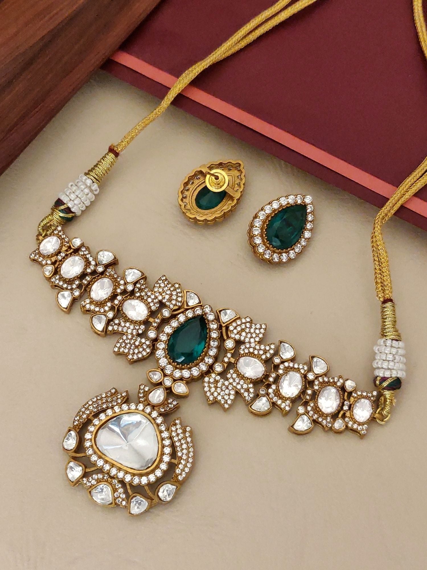 Elegant gold plated polki necklace set with intricate designs and matching earrings