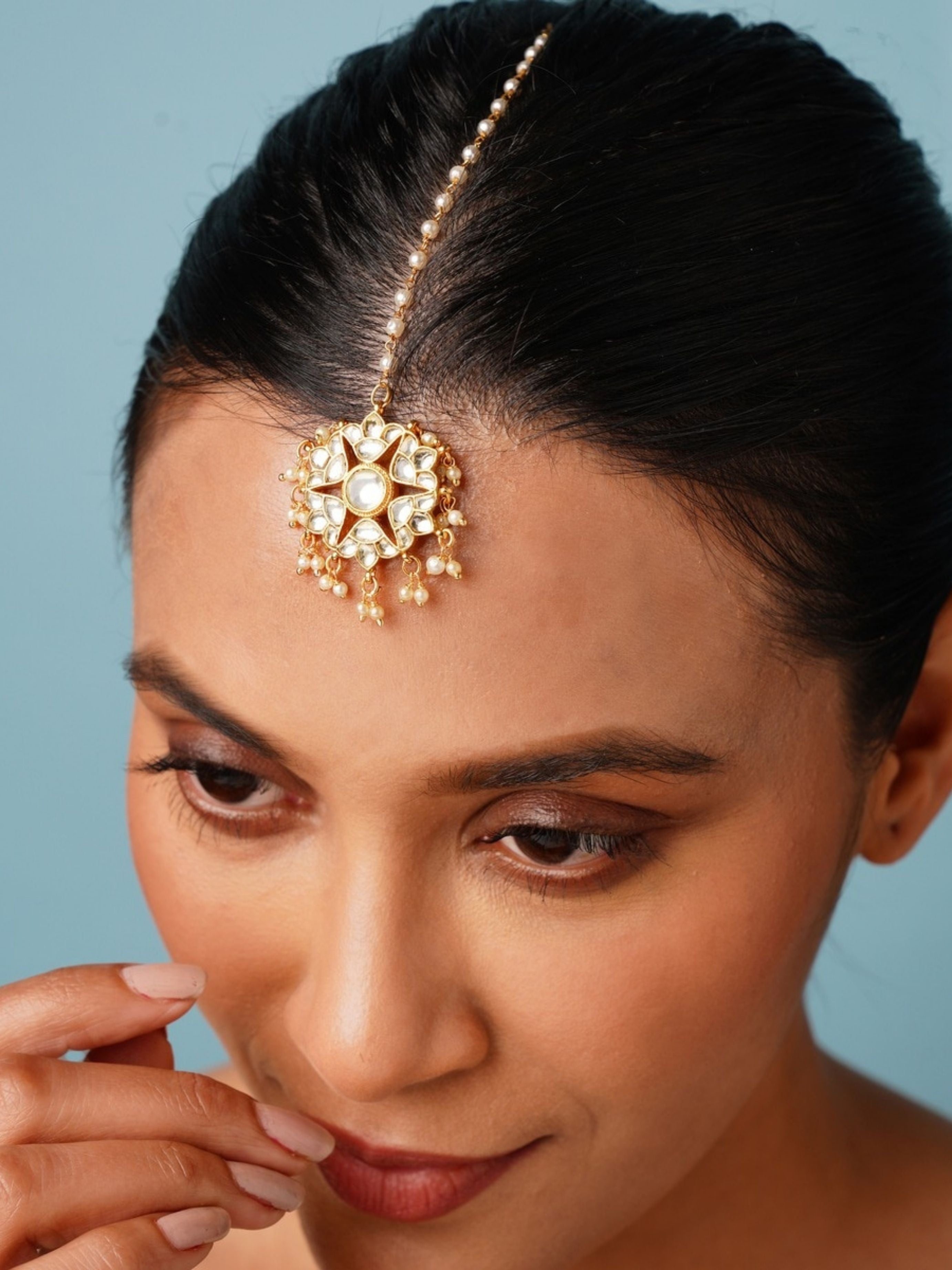 Gold Plated Polki Paachi Kundan Maangtikka worn on forehead with intricate floral design and pearl details