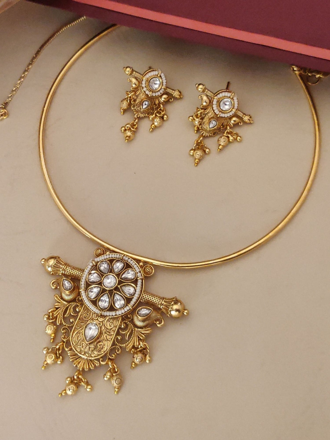 Gold Plated Polki Studed Hasli Necklace Set featuring intricate designs and matching earrings