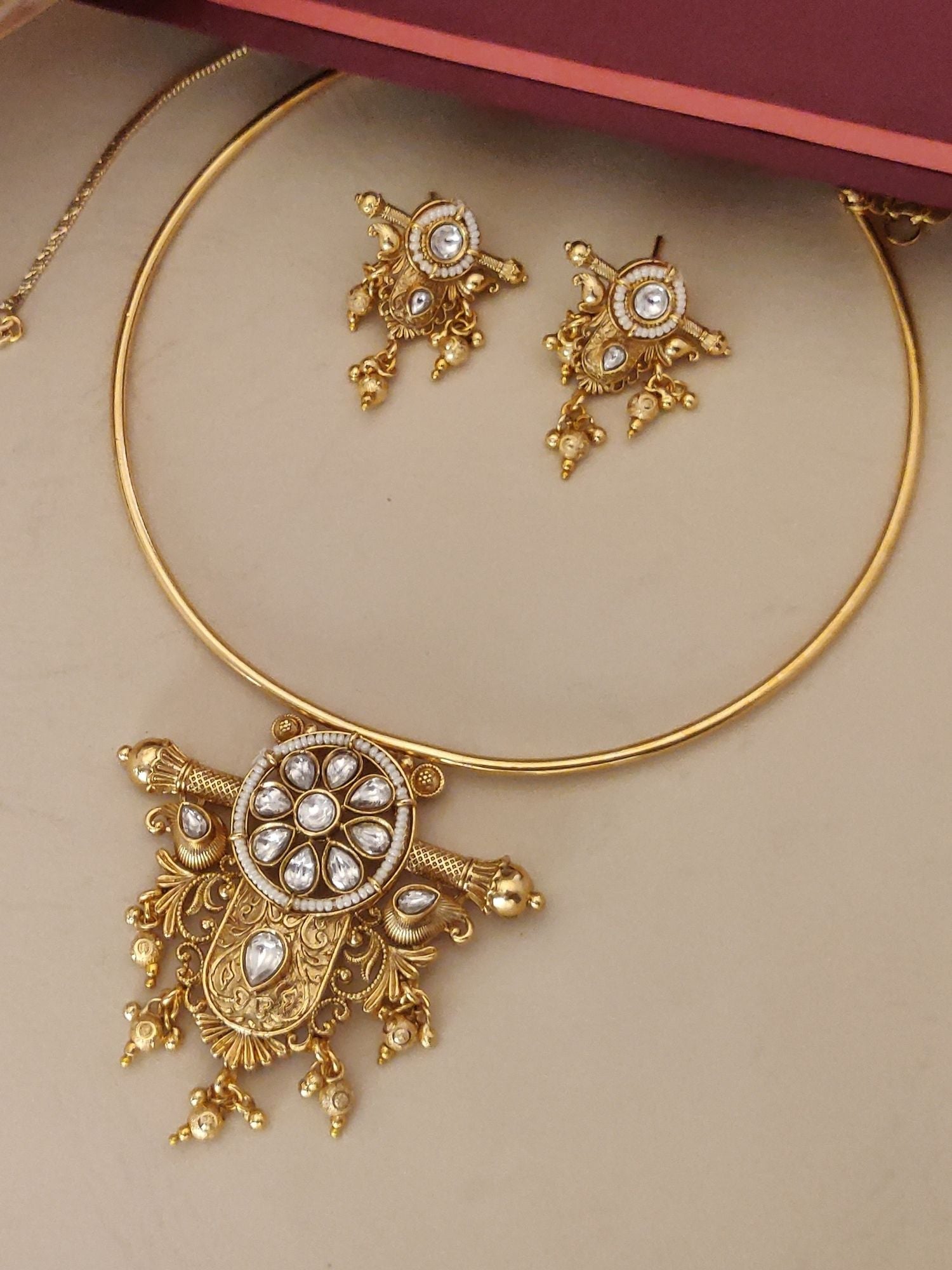 Gold Plated Polki Studed Hasli Necklace Set with intricate design and matching earrings