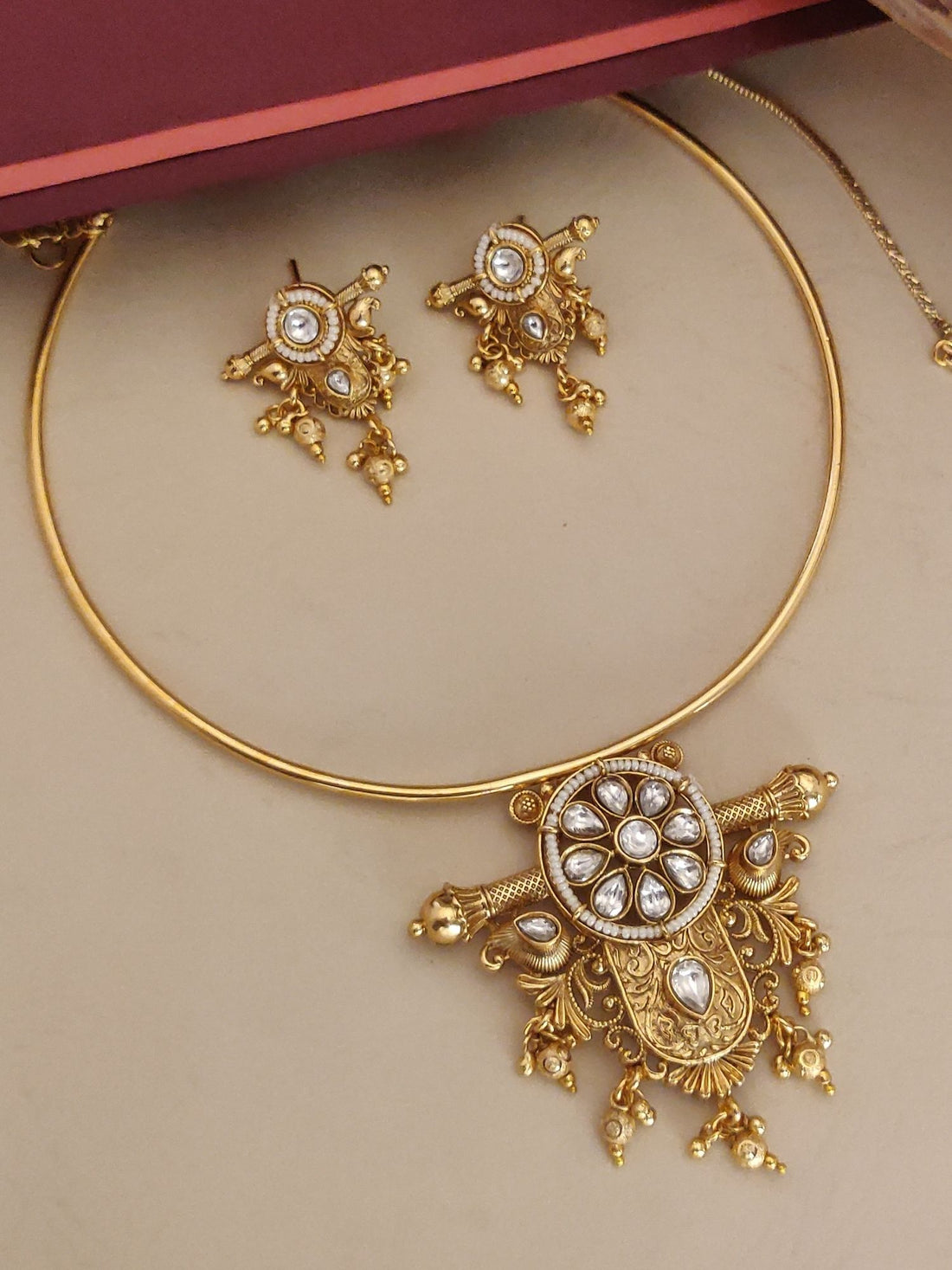 Gold Plated Polki Studed Hasli Necklace Set featuring intricate designs and matching earrings