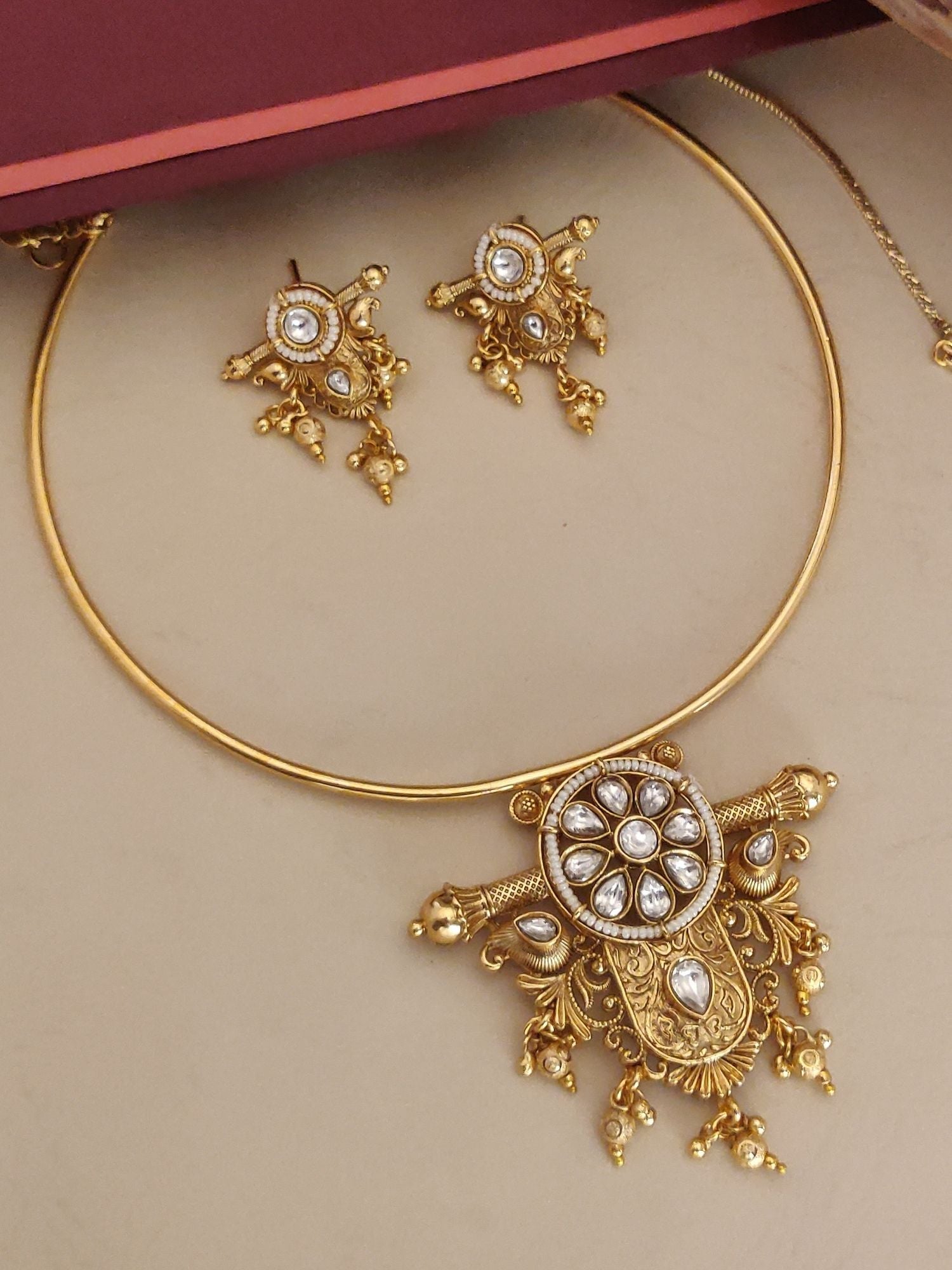 Gold Plated Polki Studed Hasli Necklace Set featuring intricate designs and matching earrings