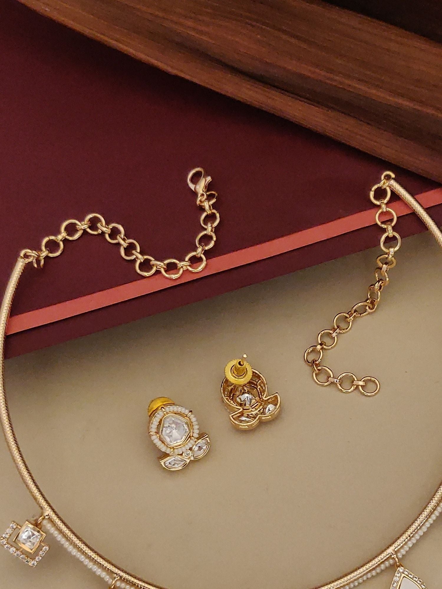Gold Plated Polki Studed Hasli Necklace Set with elegant design and matching earrings displayed together