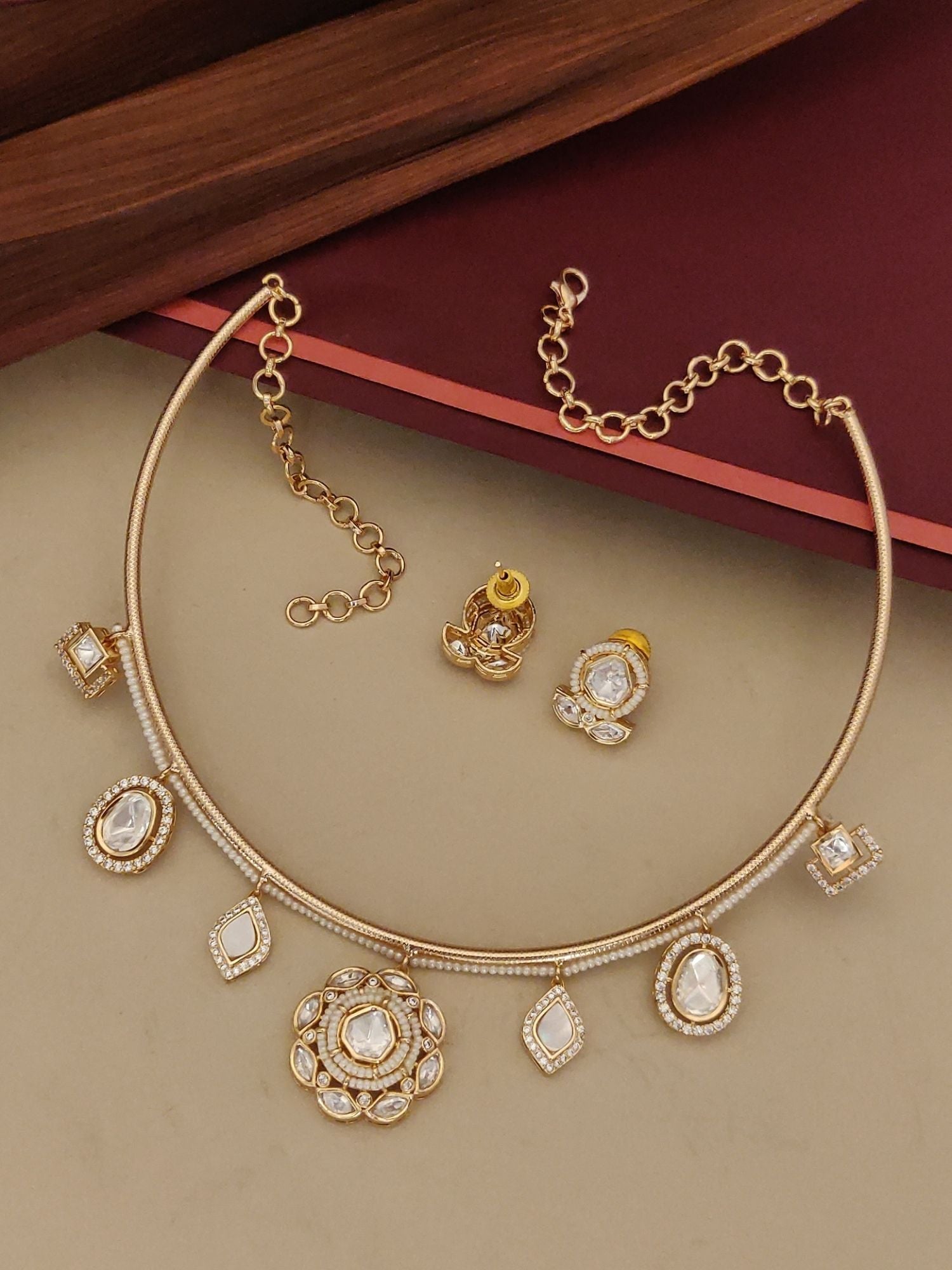 Gold Plated Polki Studed Hasli Necklace Set featuring intricate designs and matching earrings