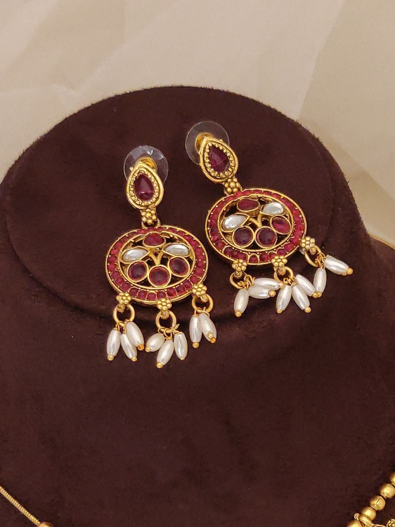 Abdesignsjewellery gold plated ruby kempstone necklace set photographed showing matching circular earrings with pearl drops