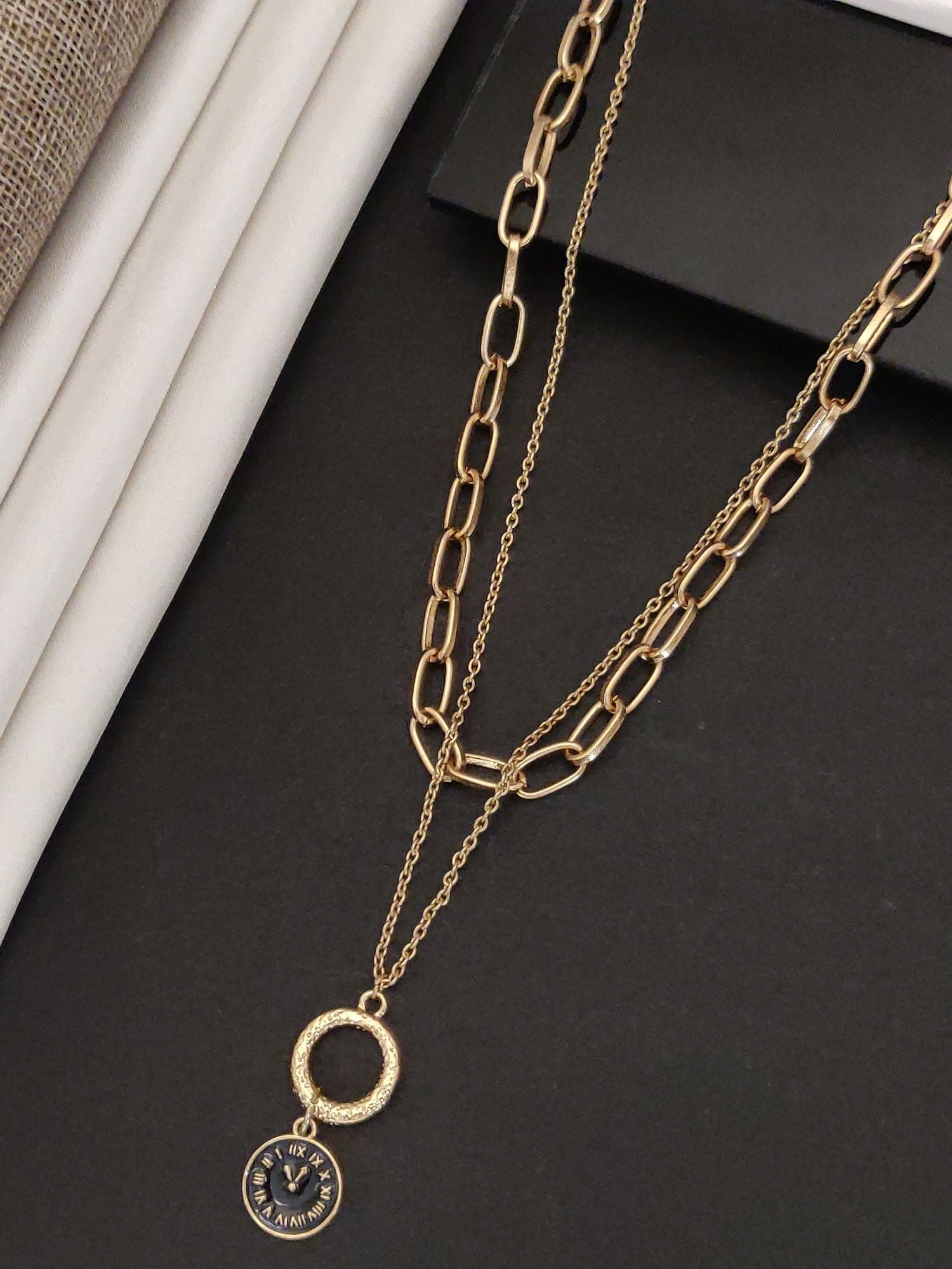 Gold plated statement necklace featuring layered chain design with a circular pendant