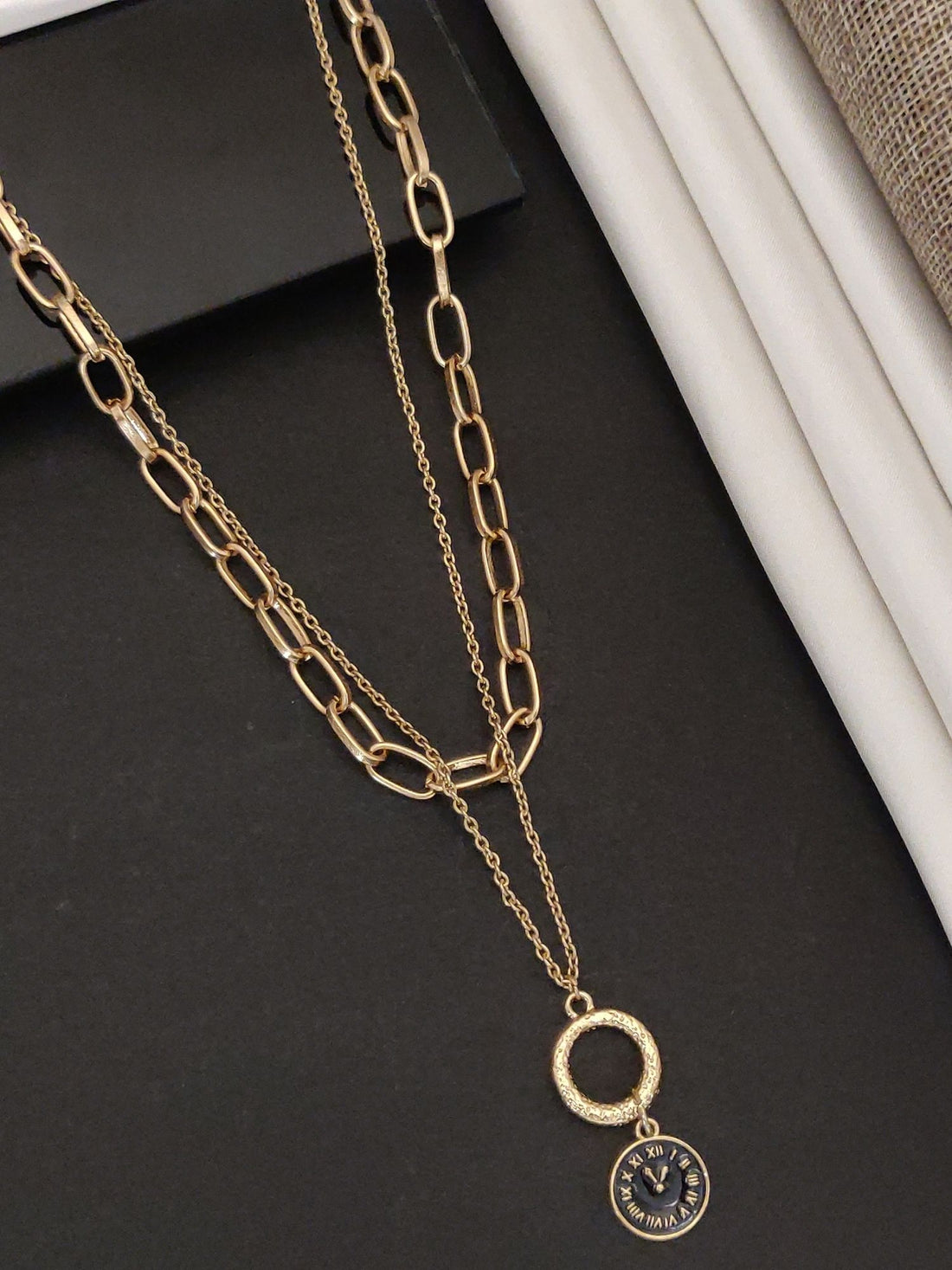 Gold plated statement necklace with layered chains and a circular pendant for a trendy look