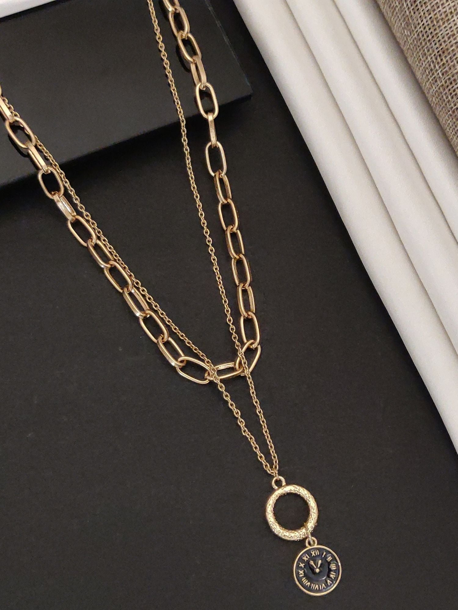 Gold plated statement necklace with layered chains and a circular pendant for a trendy look
