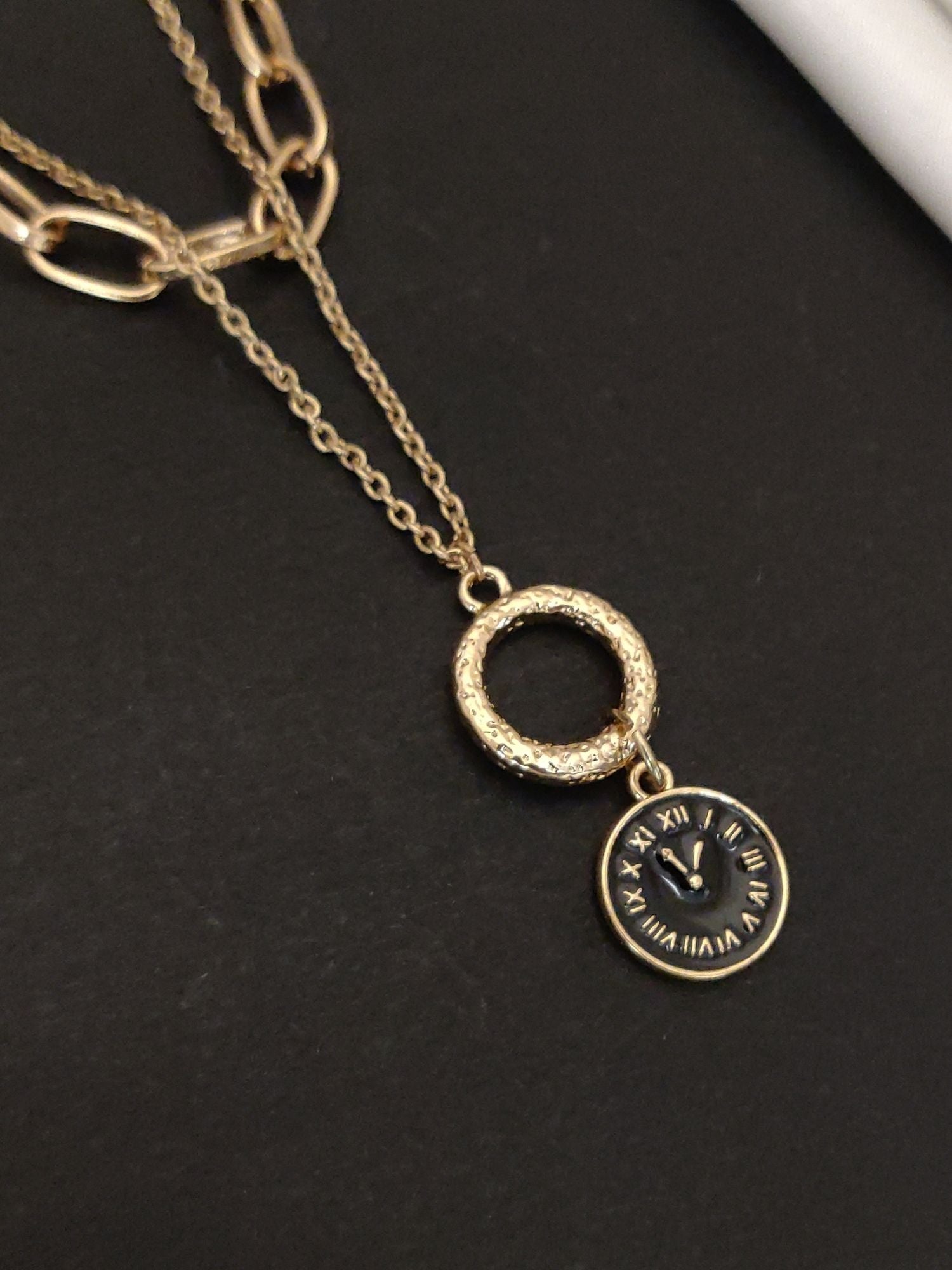Abdesignsjewellery gold plated statement necklace featuring a circular pendant with a clock design
