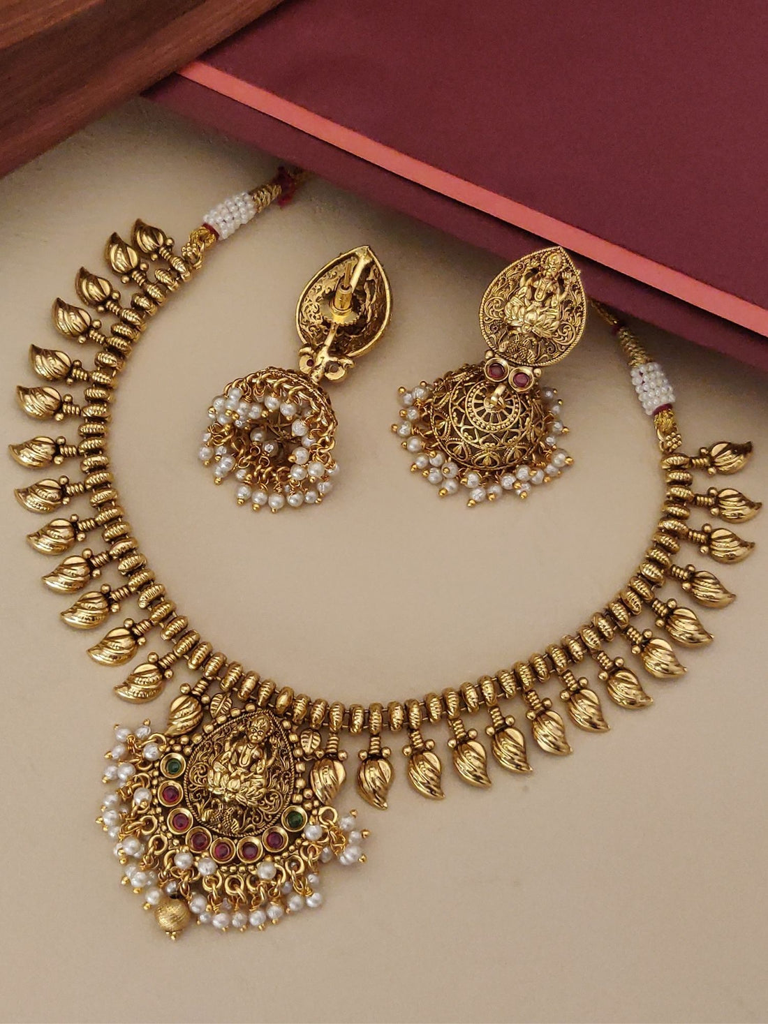 Gold plated temple necklace set with intricate design and matching earrings for elegant occasions