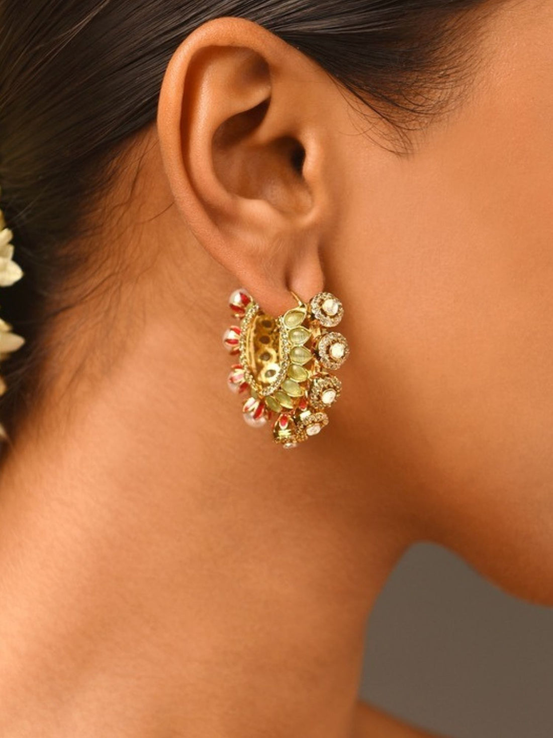 High Quality Gold Plated Artificial Stones Hoops Earrings worn by woman with sleek hair and floral adornment