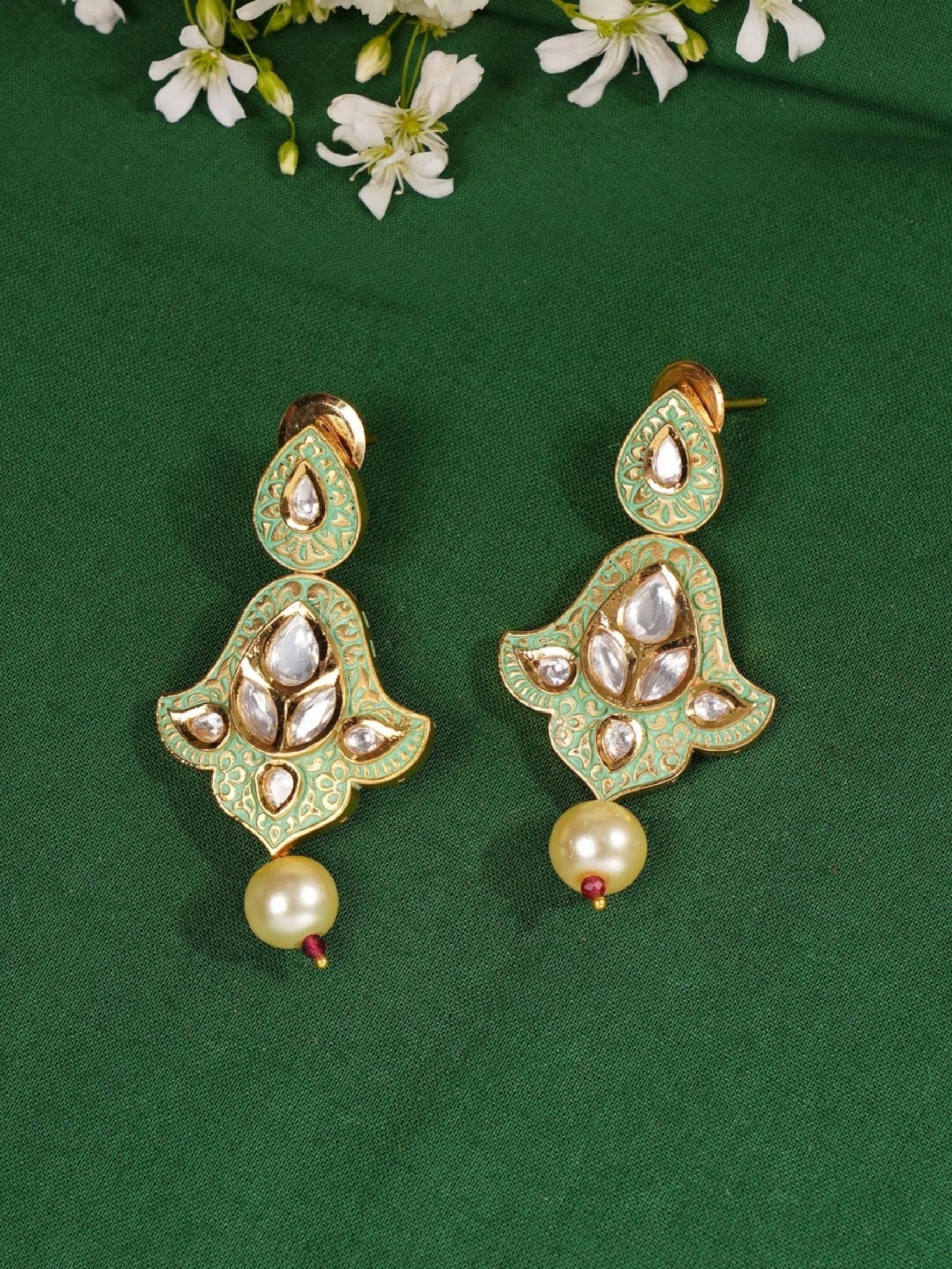 High Quality Traditional Kundan Necklace Set earrings with green and gold design and pearl drop on green fabric background