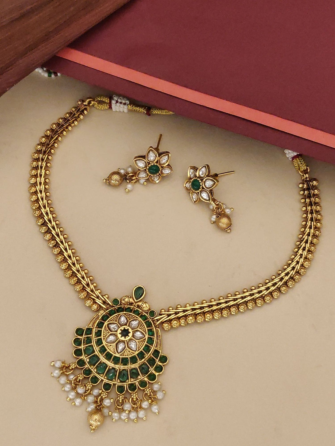 Traditional gold kemp stone necklace online with matching earrings and intricate design