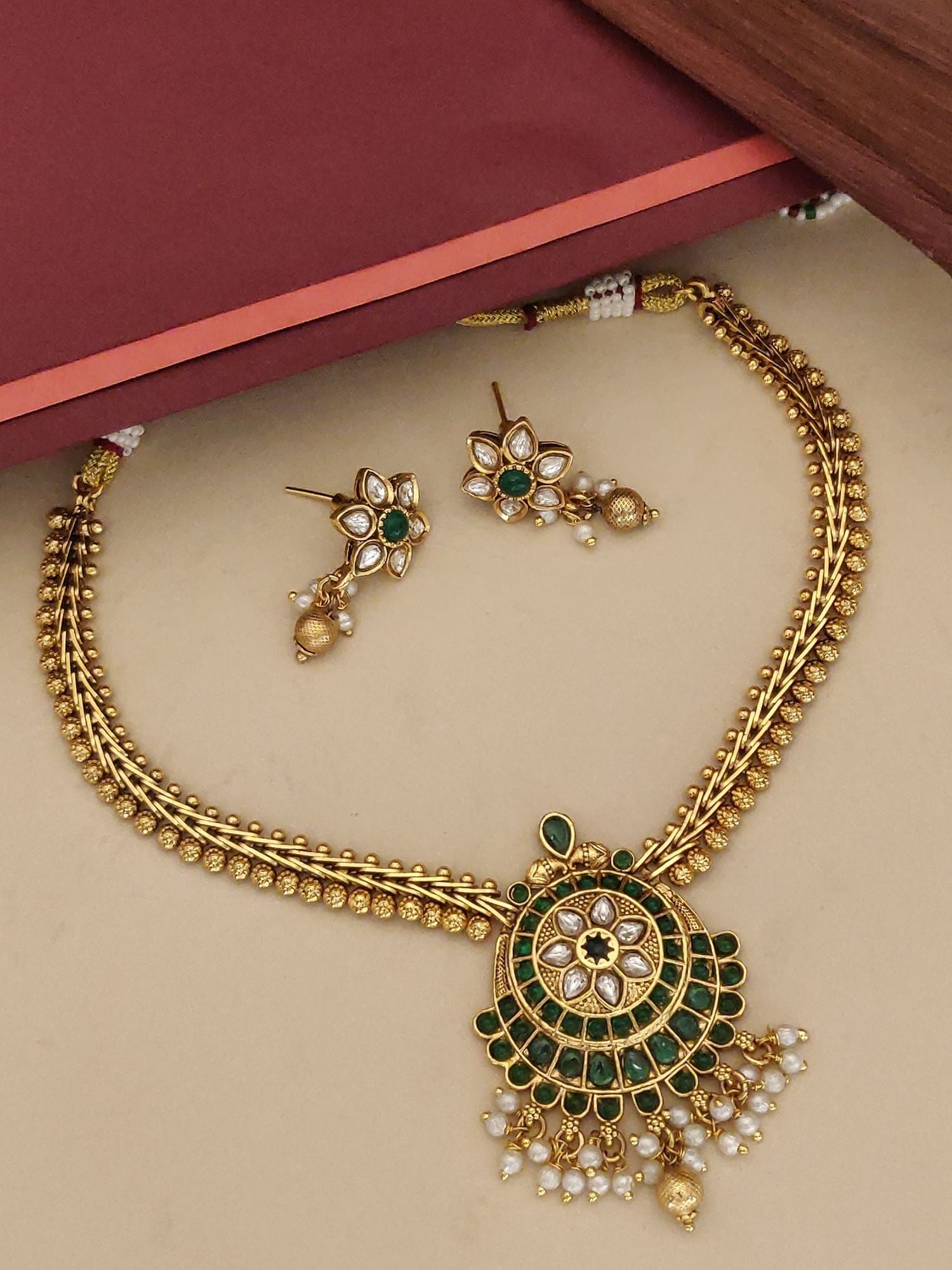 Traditional gold kemp stone necklace online with matching earrings and intricate design