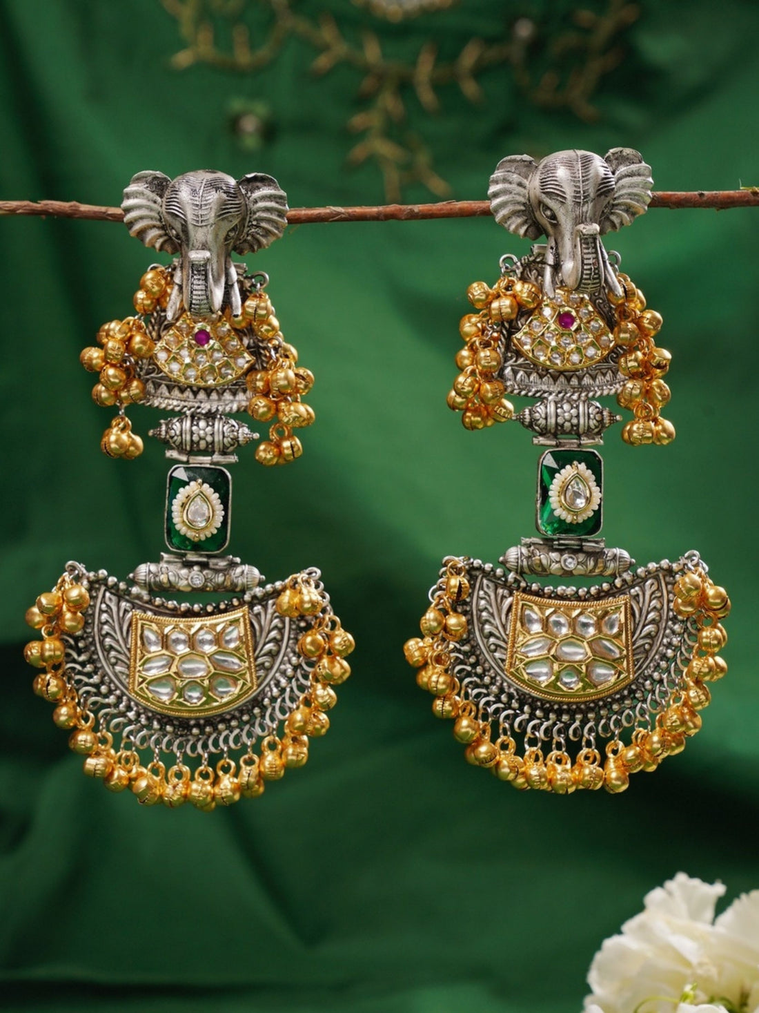 Close-up of a woman wearing Abdesignsjewellery Long Dual Tone Elephant Chandbali Earring with intricate gold and silver detailing