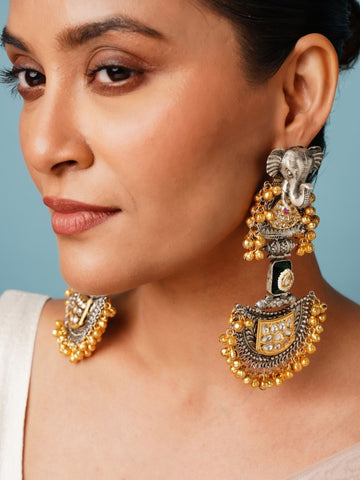 Close-up of a woman wearing Abdesignsjewellery Long Dual Tone Elephant Chandbali Earring with intricate gold and silver detailing