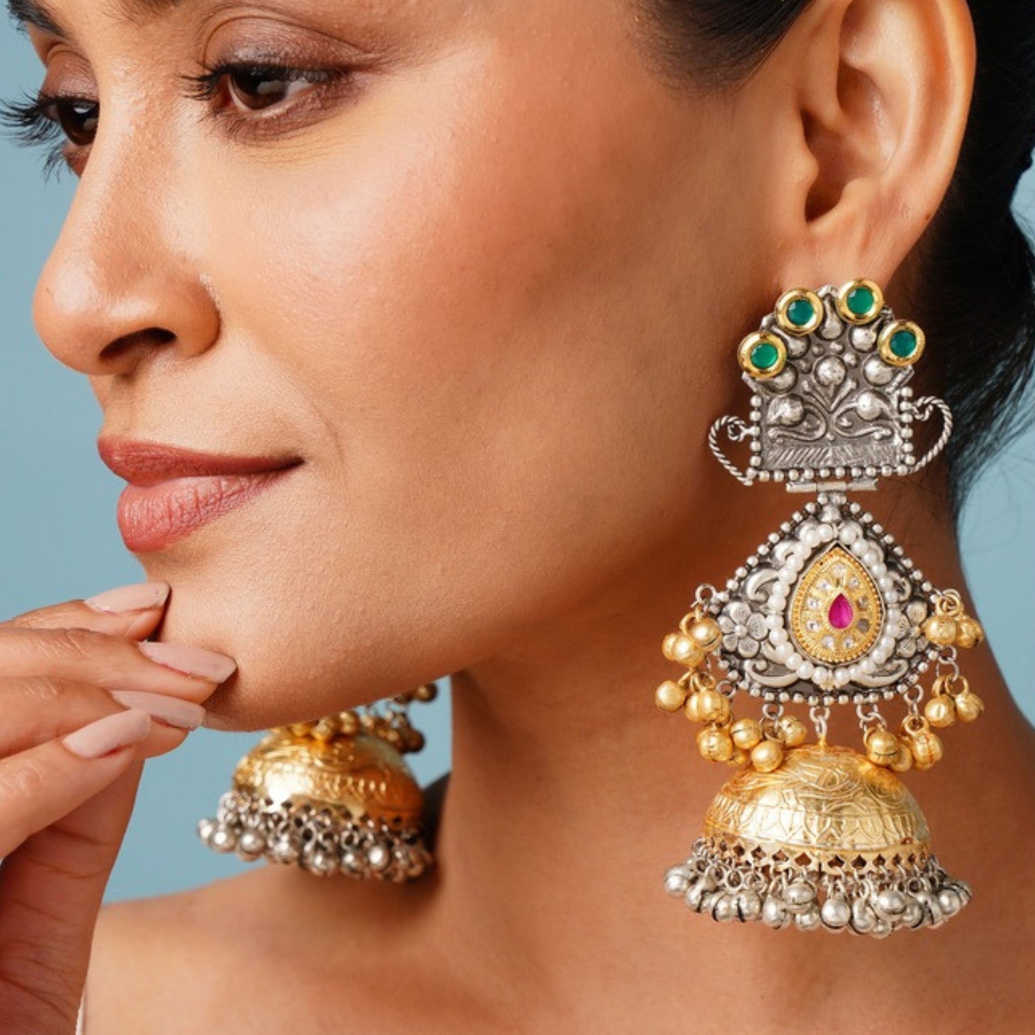 Long DualTone Plated Celebrity Style Jhumka Earrings by Abdesignsjewellery worn on woman with intricate gold and silver detailing