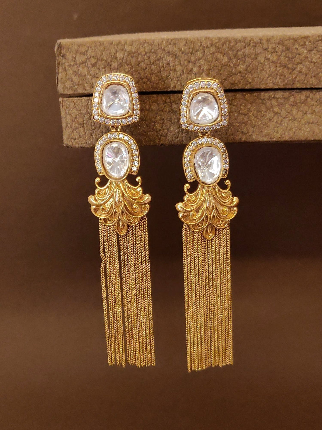 Stunning long gold plated polki earrings with intricate design and elegant fringe detail