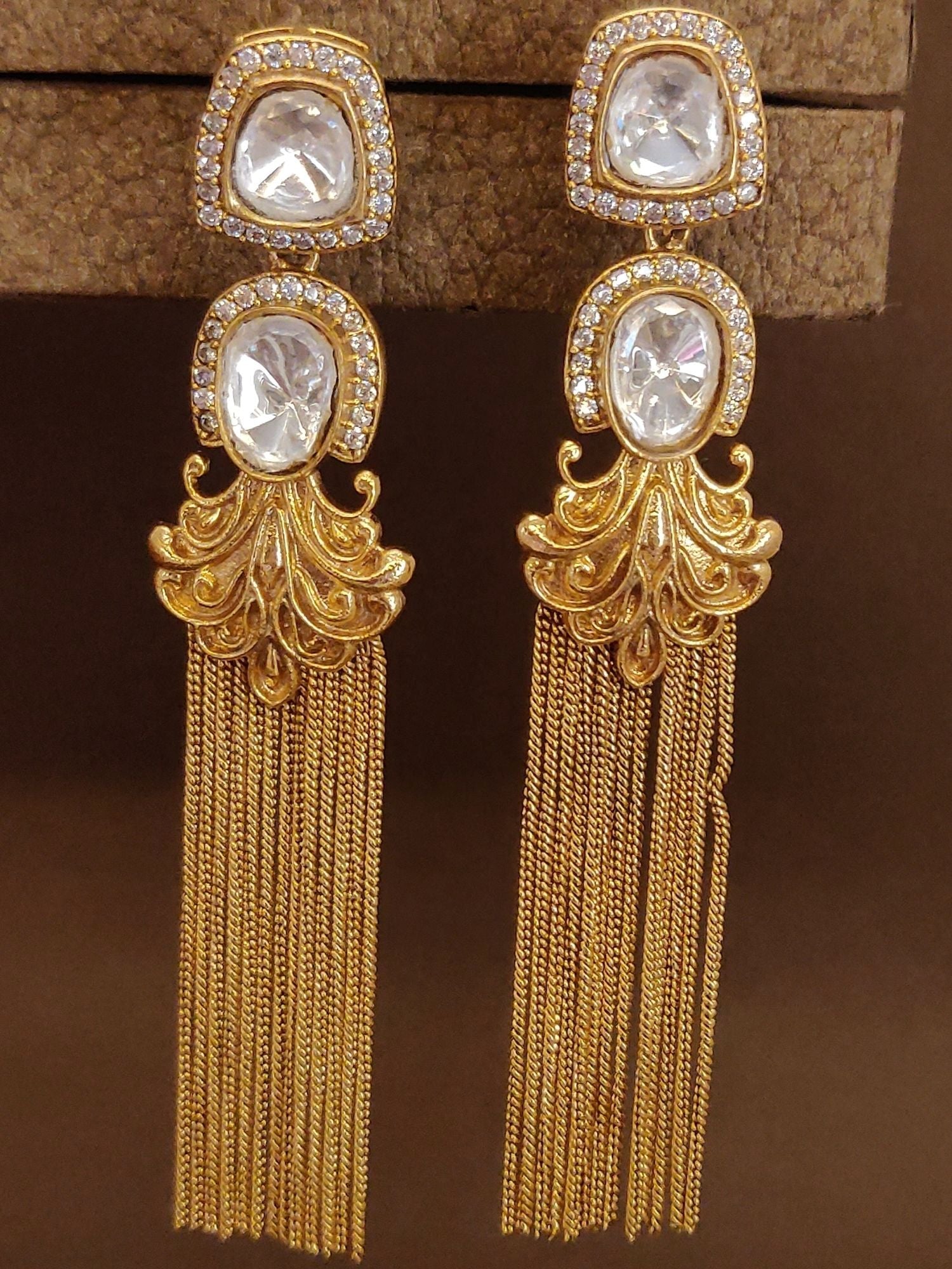 Long gold plated polki earrings featuring intricate design and dazzling crystals
