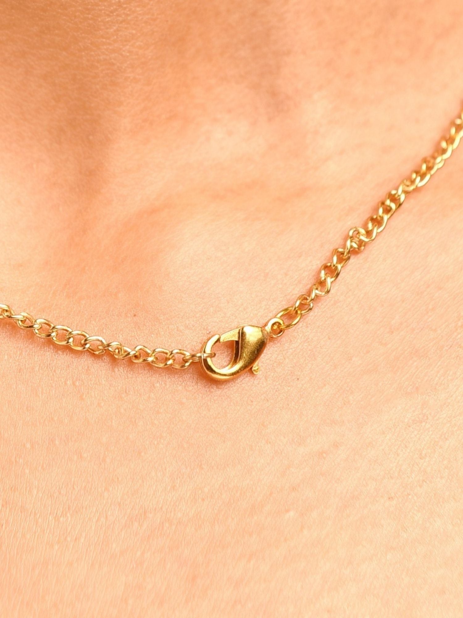 Close-up of luxurious gold plated polki pendant chain clasp on skin by Abdesignsjewellery