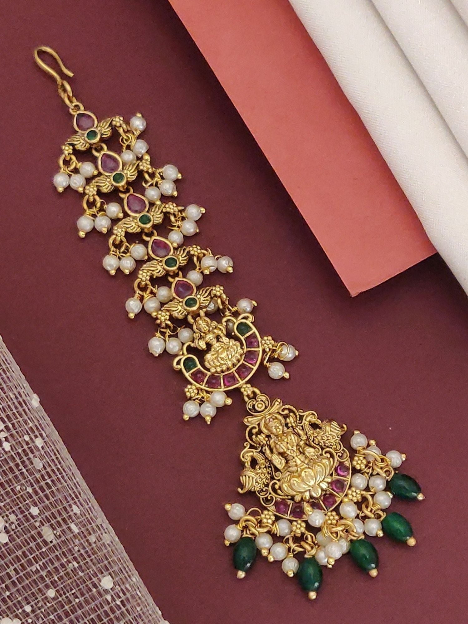 Abdesignsjewellery Matt gold plated head maangtikka with temple goddess motif pearl and green bead dangles