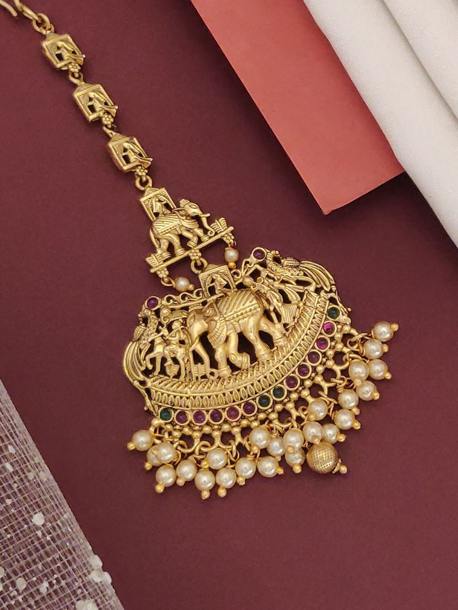 Matt Gold Plated KempStone Elephant Maangtikka with intricate designs and pearl embellishments