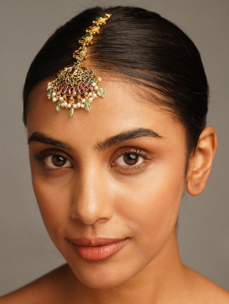 Matt Gold Plated KempStone Studed Maangtikka worn on forehead by woman with sleek hair