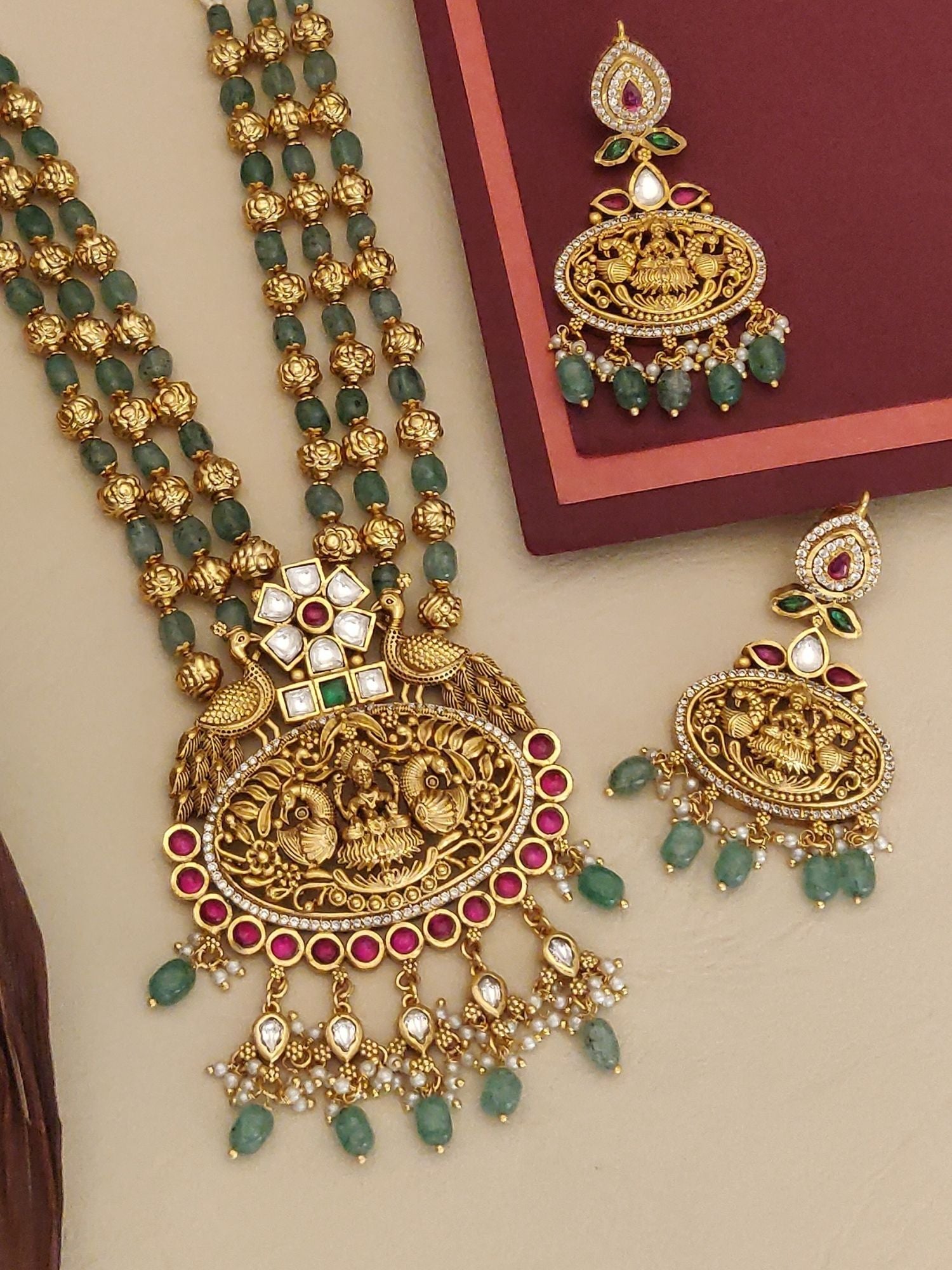 Matt Gold Temple Necklace Set with intricate design and matching earrings featuring colorful stones