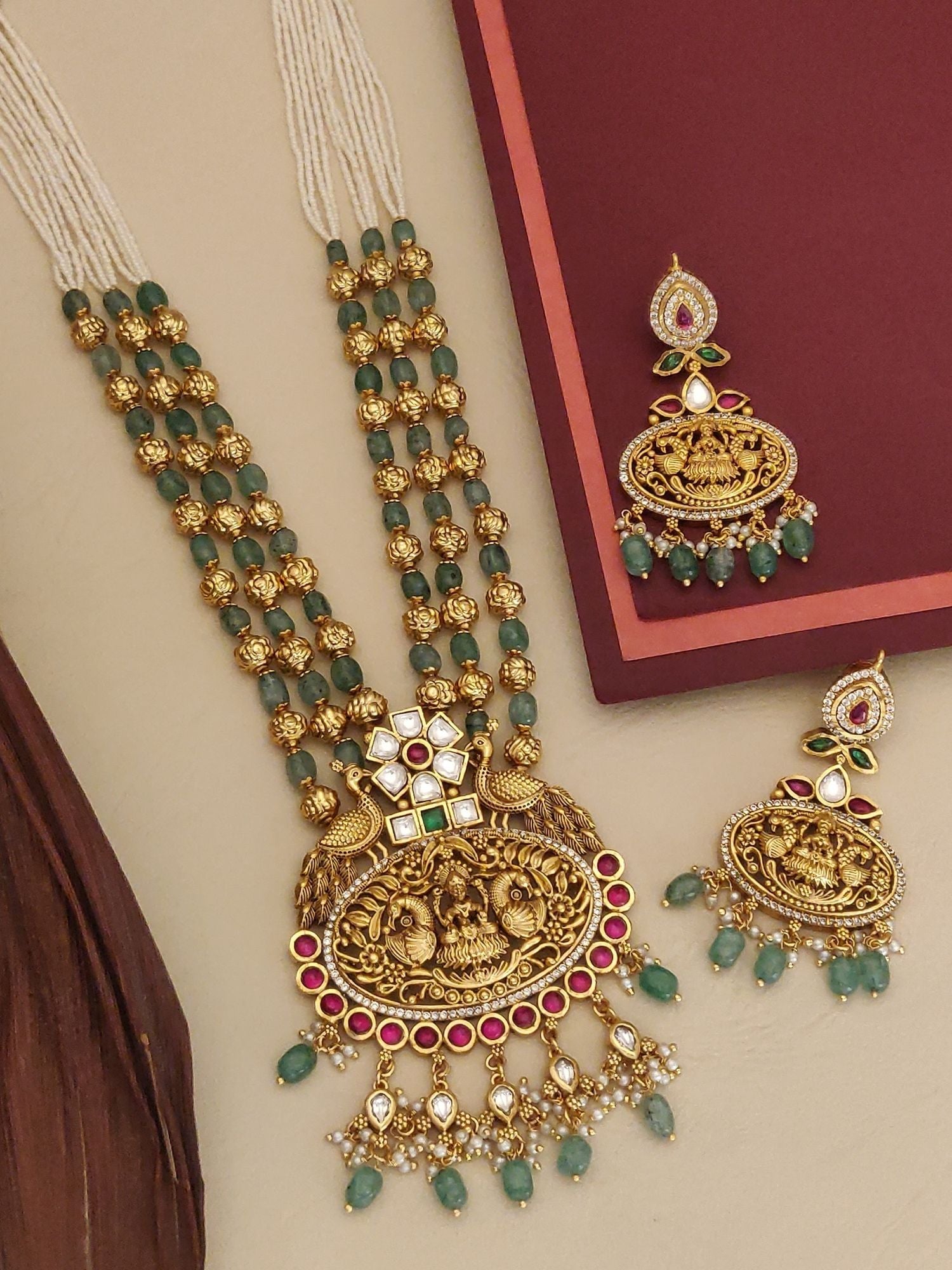 Matt Gold Temple Necklace Set with intricate design and green gemstones, accompanied by matching earrings