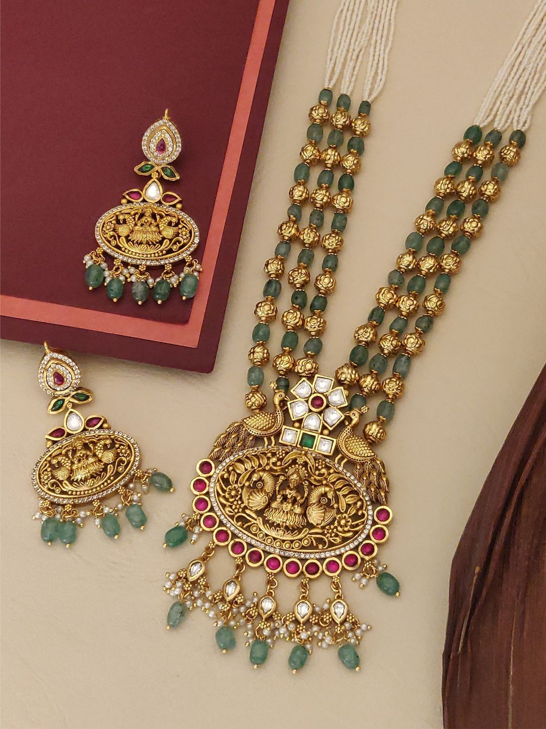 Matt Gold Temple Necklace Set with intricate design and green gemstones, accompanied by matching earrings