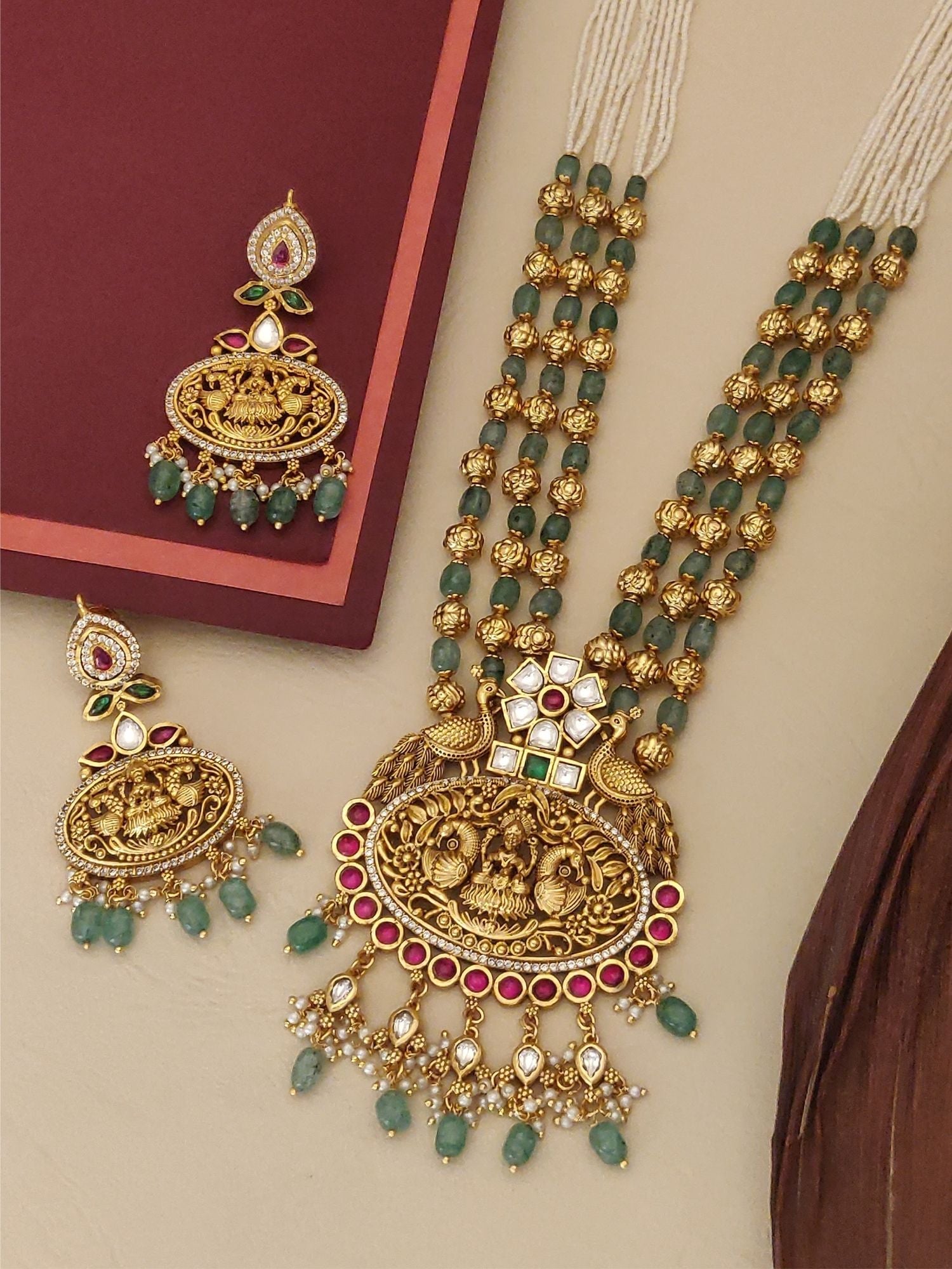 Matt Gold Temple Necklace Set with intricate design, complemented by matching earrings and green beads