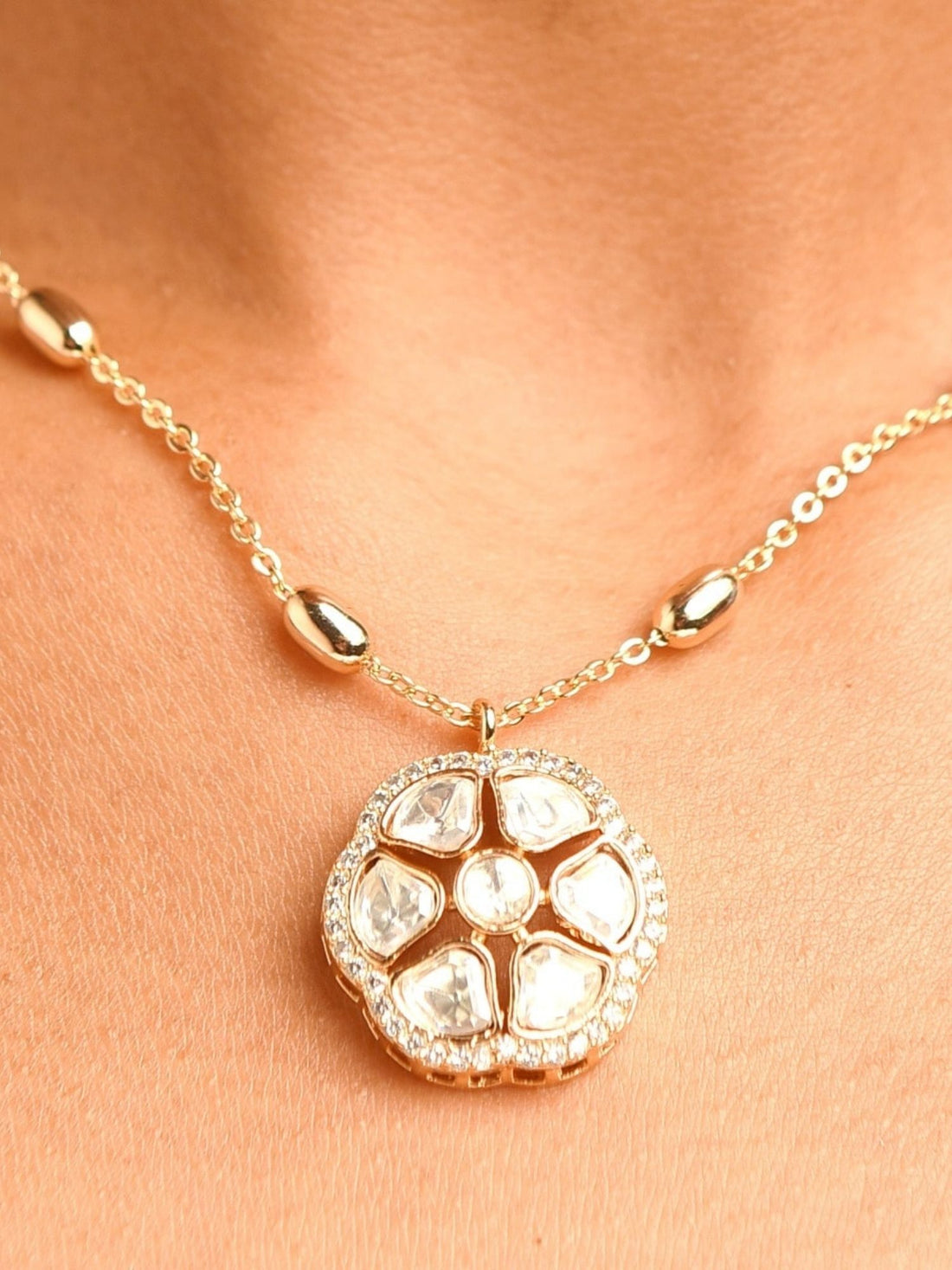 Premium Quality Gold Plated Polki Pendant Chain worn by woman with elegant red dress and floral earrings