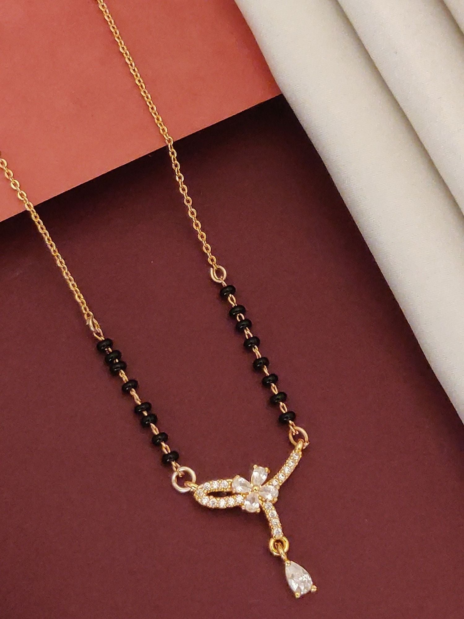 Elegant rose gold plated mangalsutra with intricate design and gemstone accents