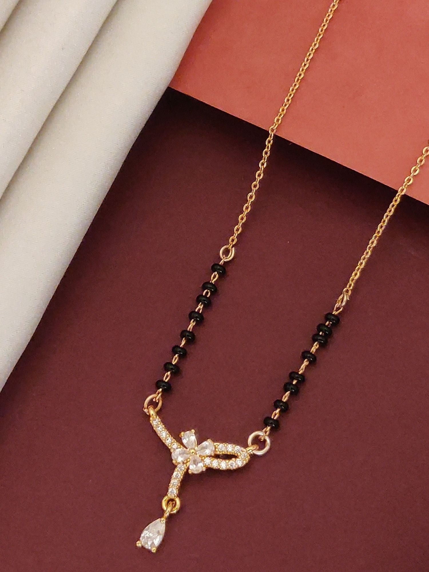 Elegant rose gold plated mangalsutra with diamond accents and black beads for a modern look