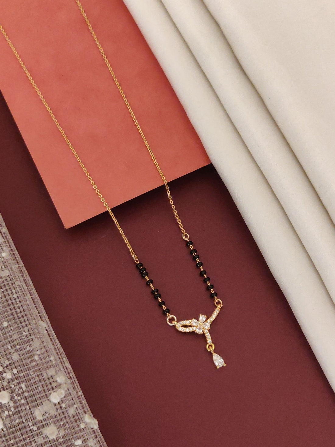 Elegant rose gold plated mangalsutra with intricate diamond-like design and black beads